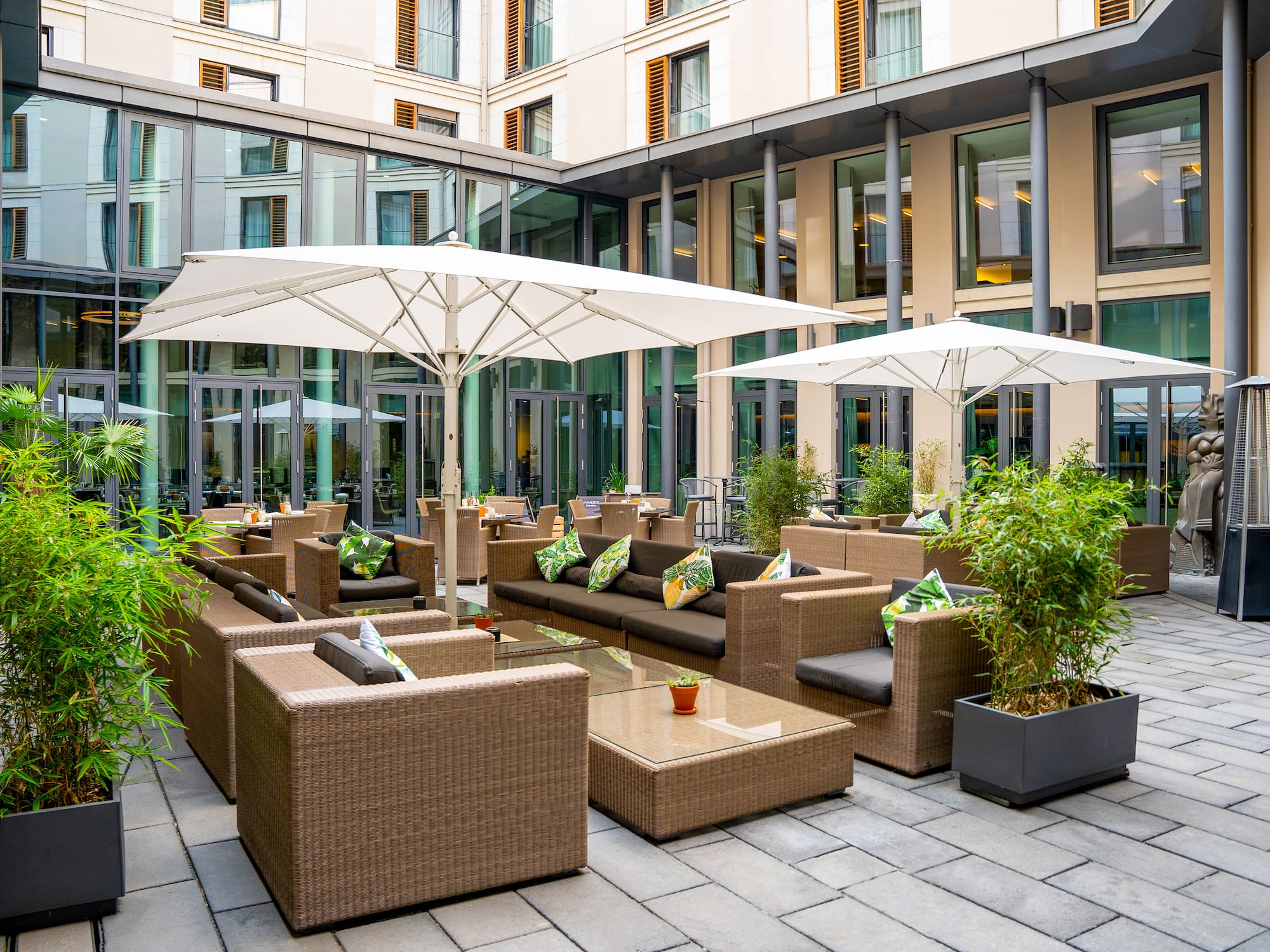 a patio area with chairs and umbrellas