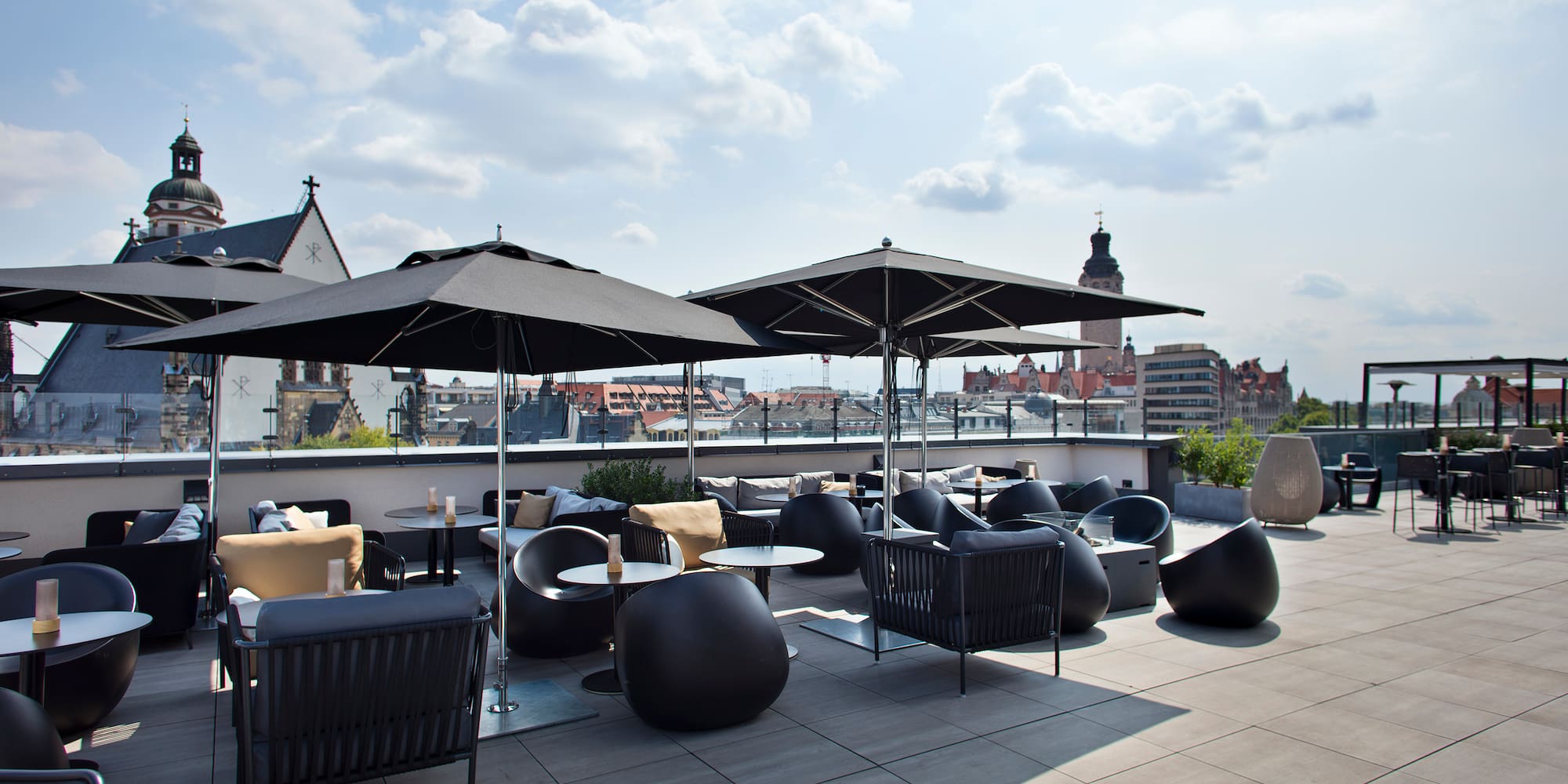 a patio with chairs and umbrellas