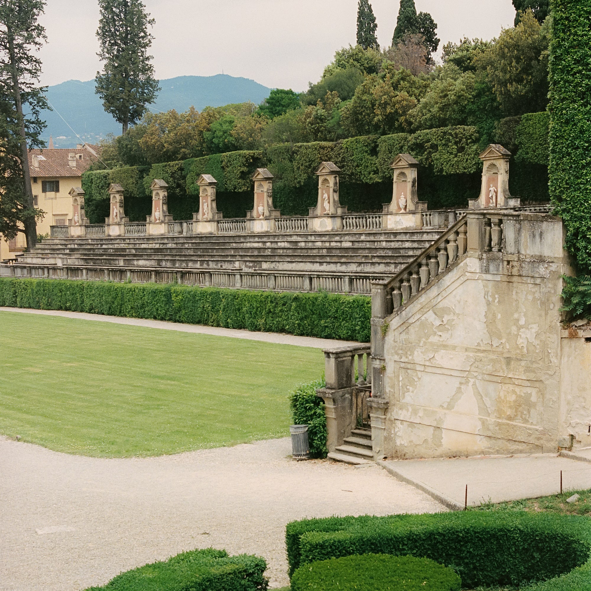 a stone stairs leading to a green lawn