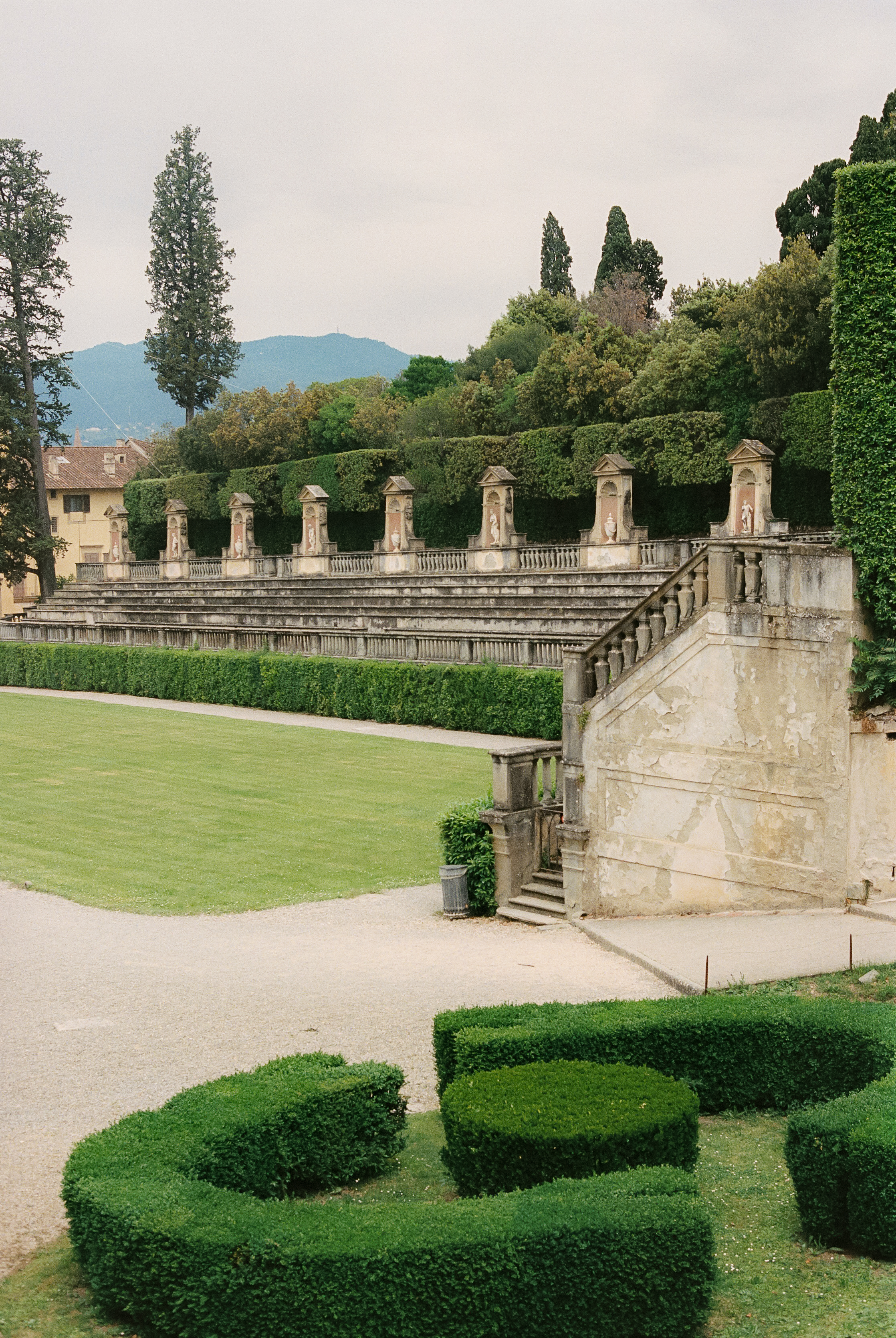a stone stairs leading to a green lawn
