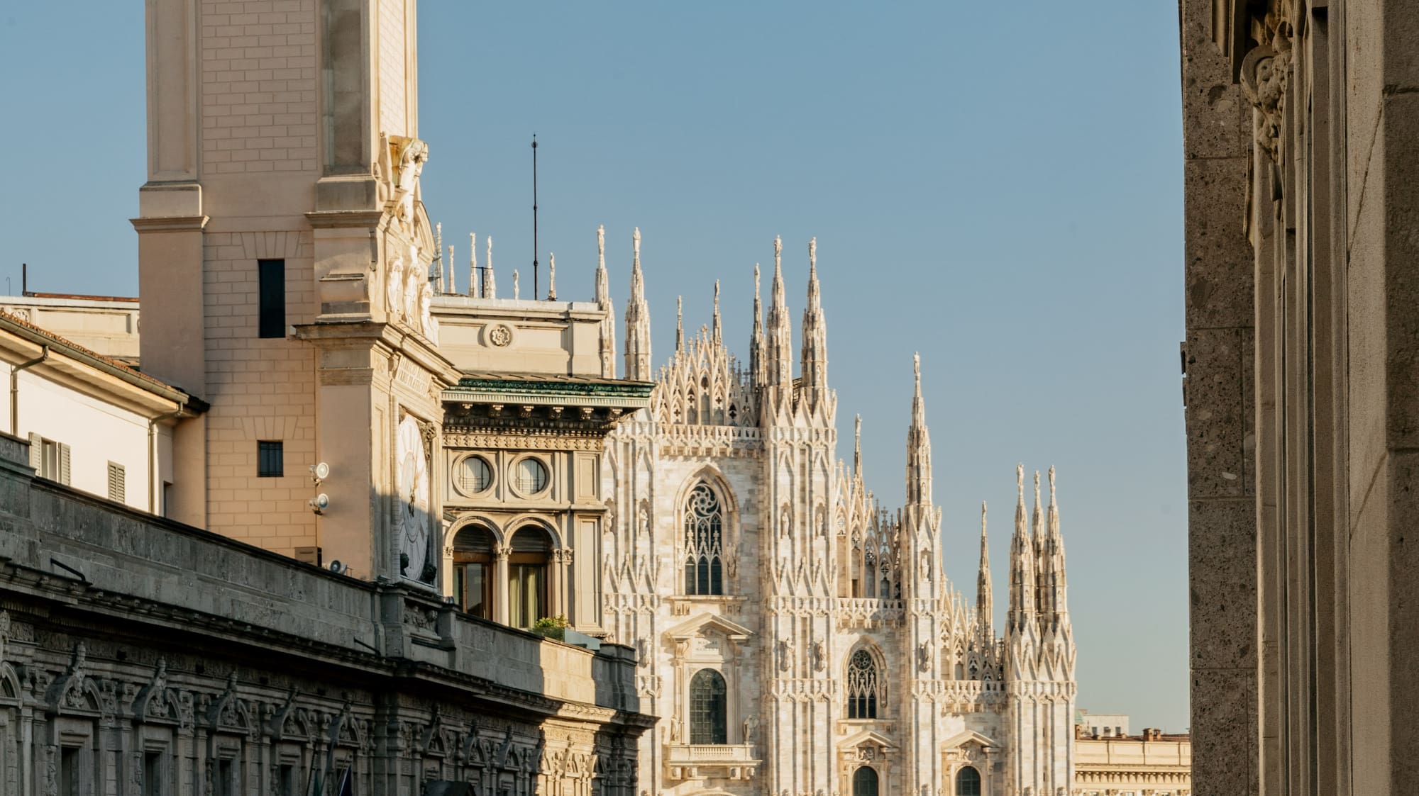 a group of people walking in front of a large building