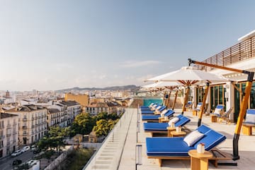 a deck with chairs and umbrellas on a rooftop