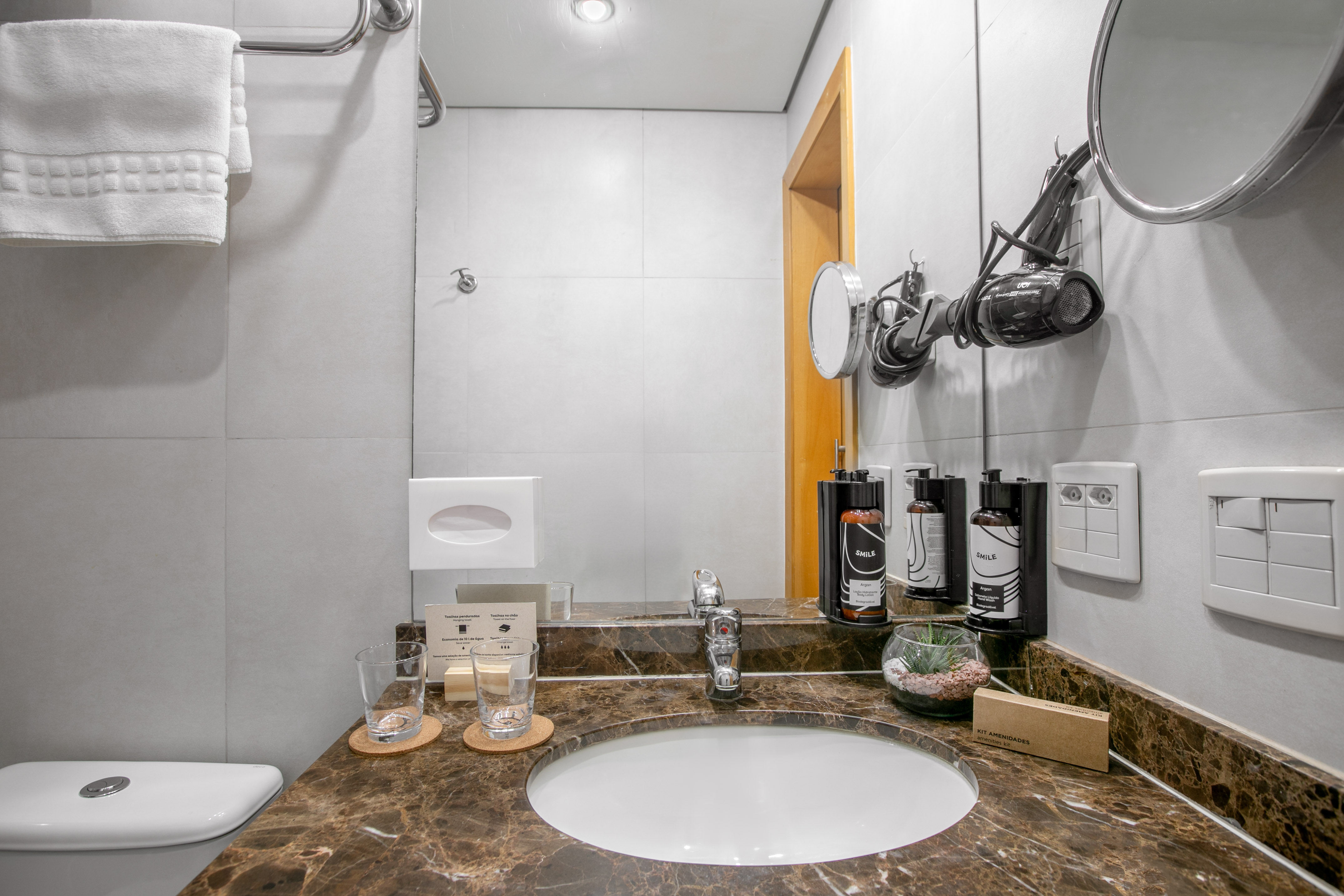 Marble bathroom vanity with sink, mirror, hairdryer, and hotel amenities. - The INNSiDE Room Twin - INNSiDE São Paulo Higienópolis, Sao Paulo