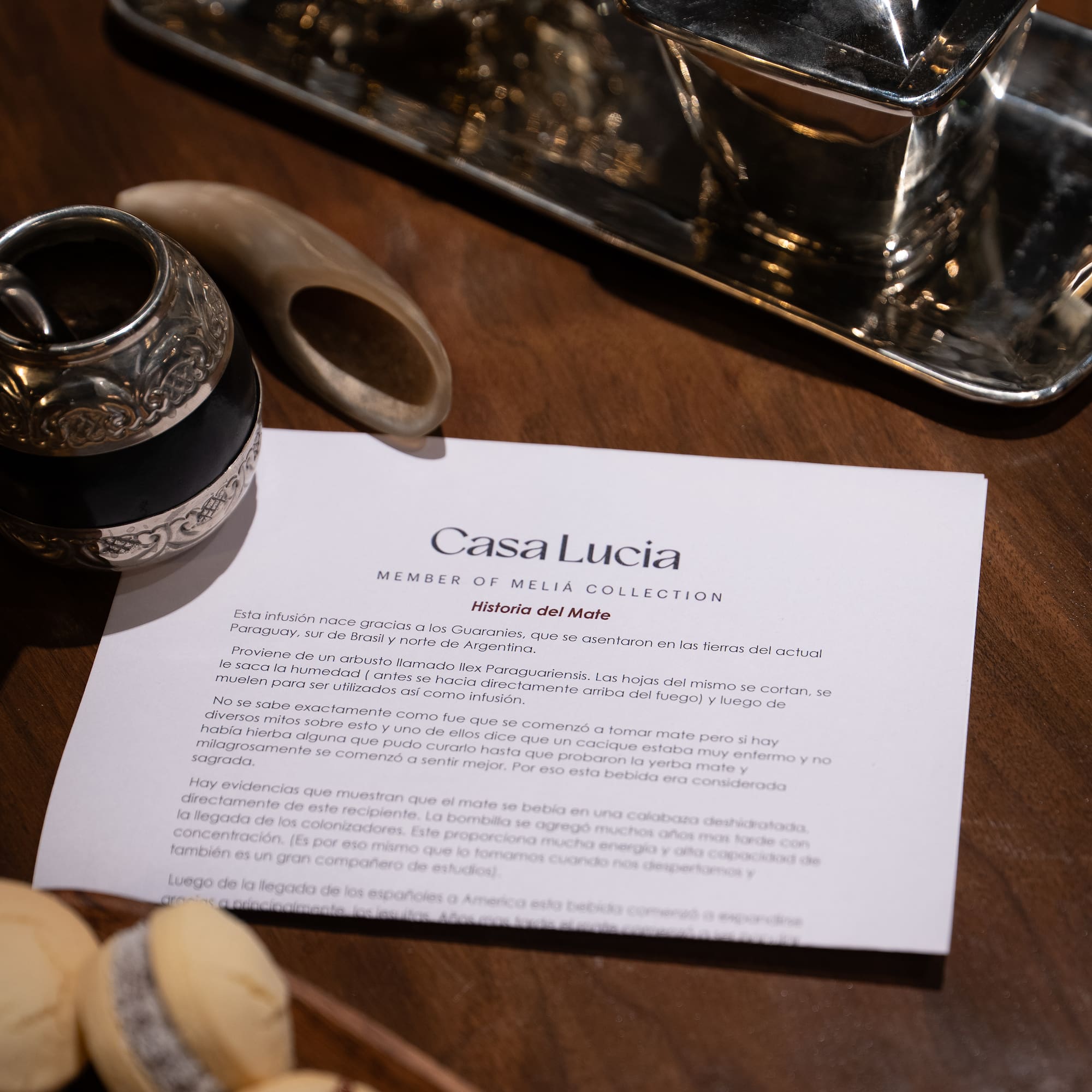 a paper with a silver object on it next to a silver tray