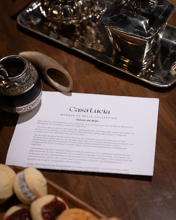 a paper with a silver object on it next to a silver tray