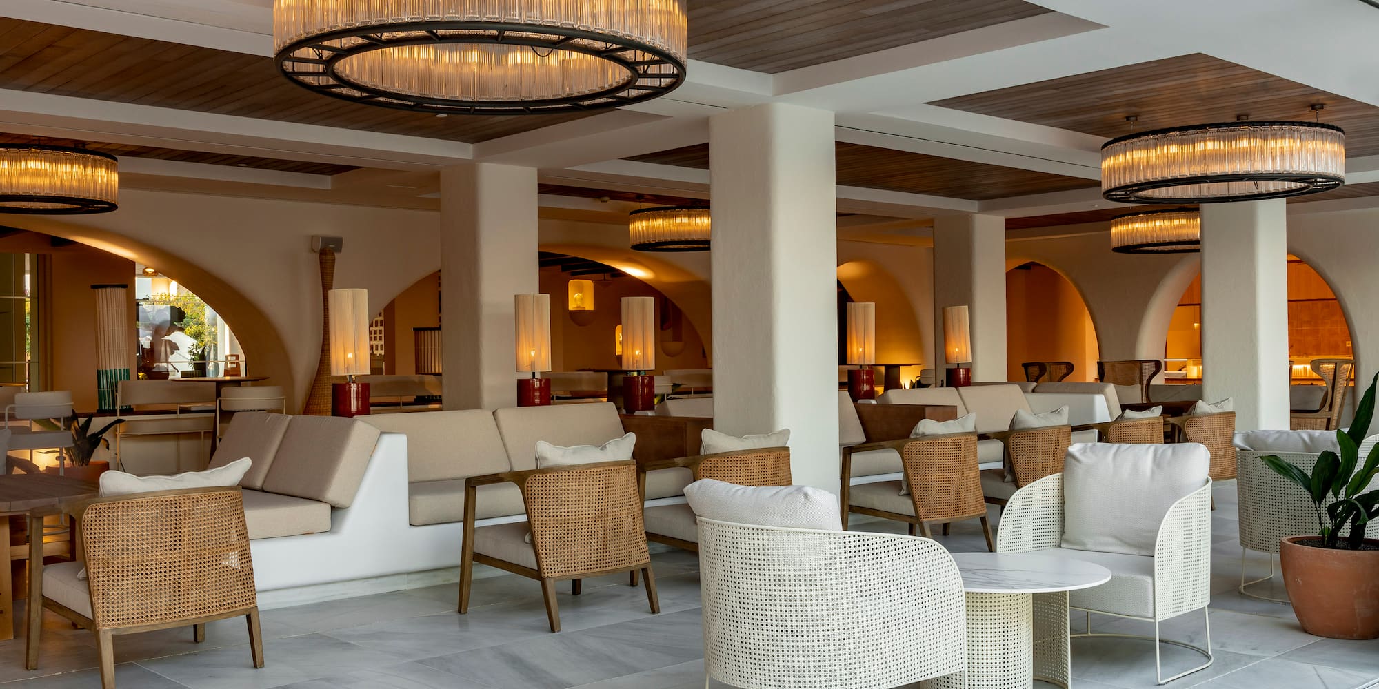 a room with chairs and tables and a chandelier