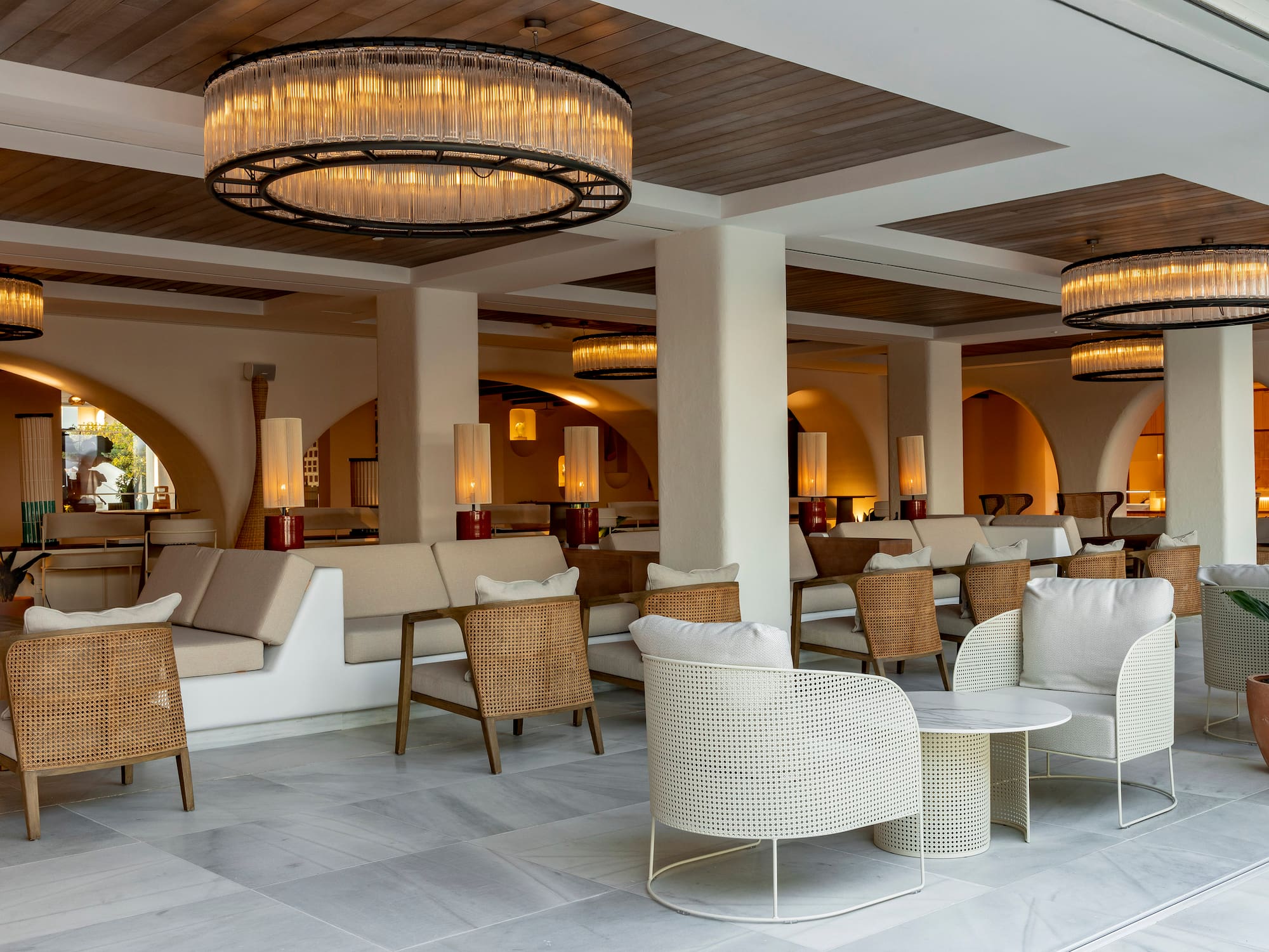 a room with chairs and tables and a chandelier