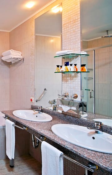 a bathroom with two sinks and a shower