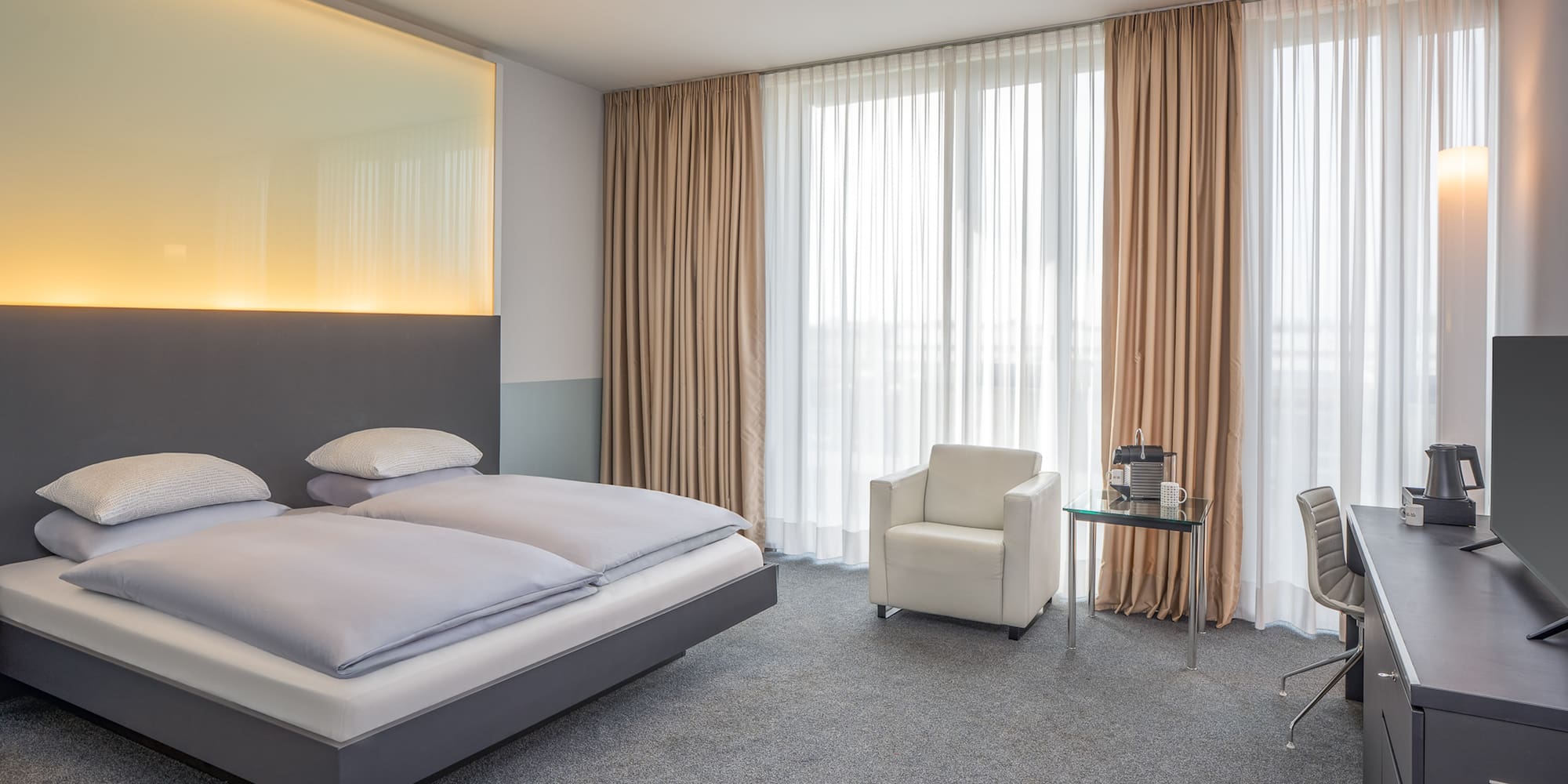 a bedroom with a bed and chair