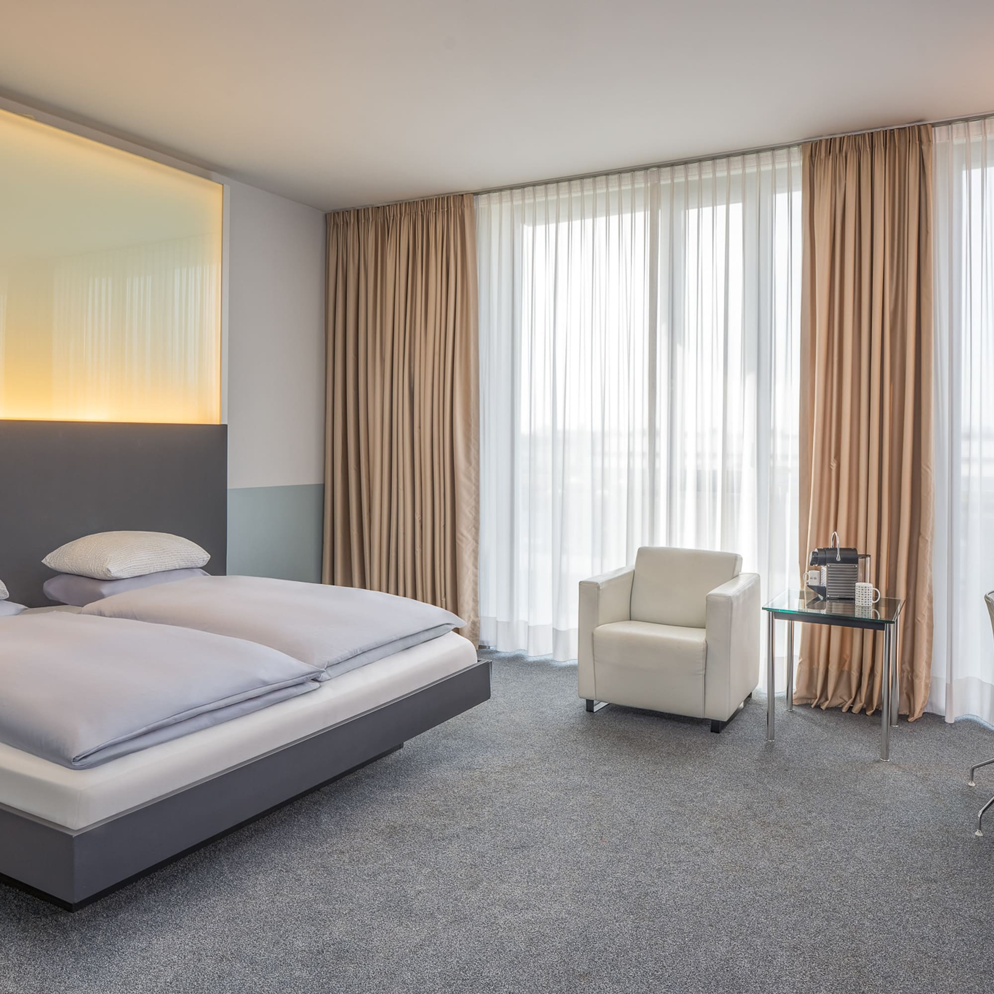 a bedroom with a bed and chair