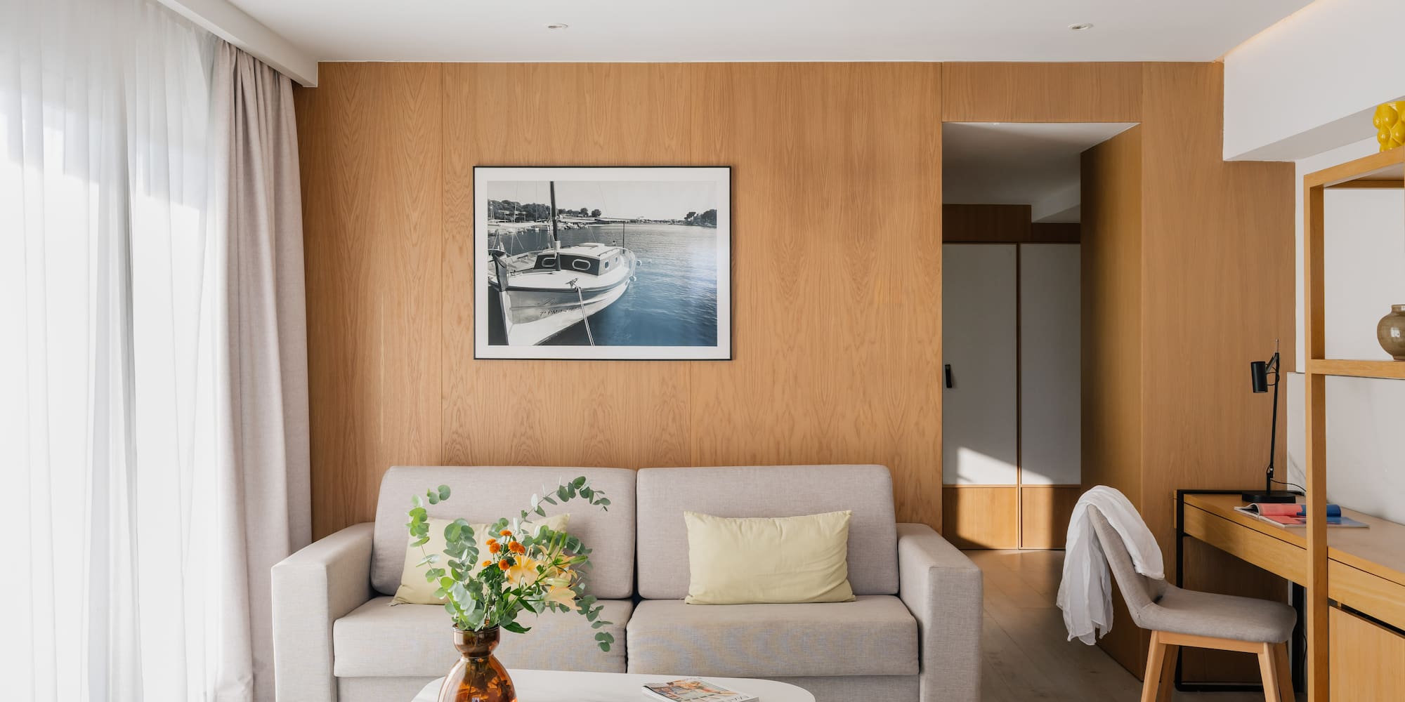 a living room with a couch and a picture on the wall