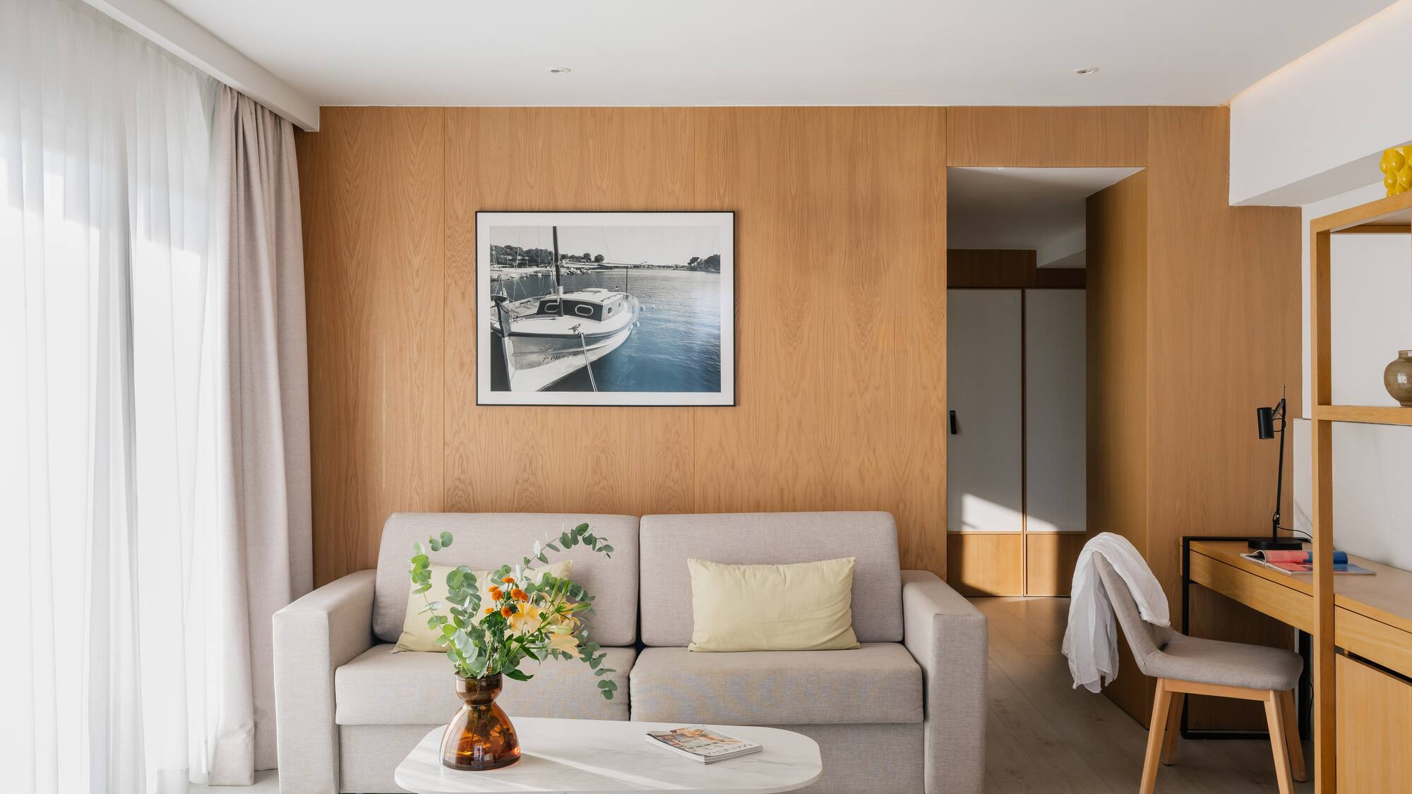 a living room with a couch and a picture on the wall