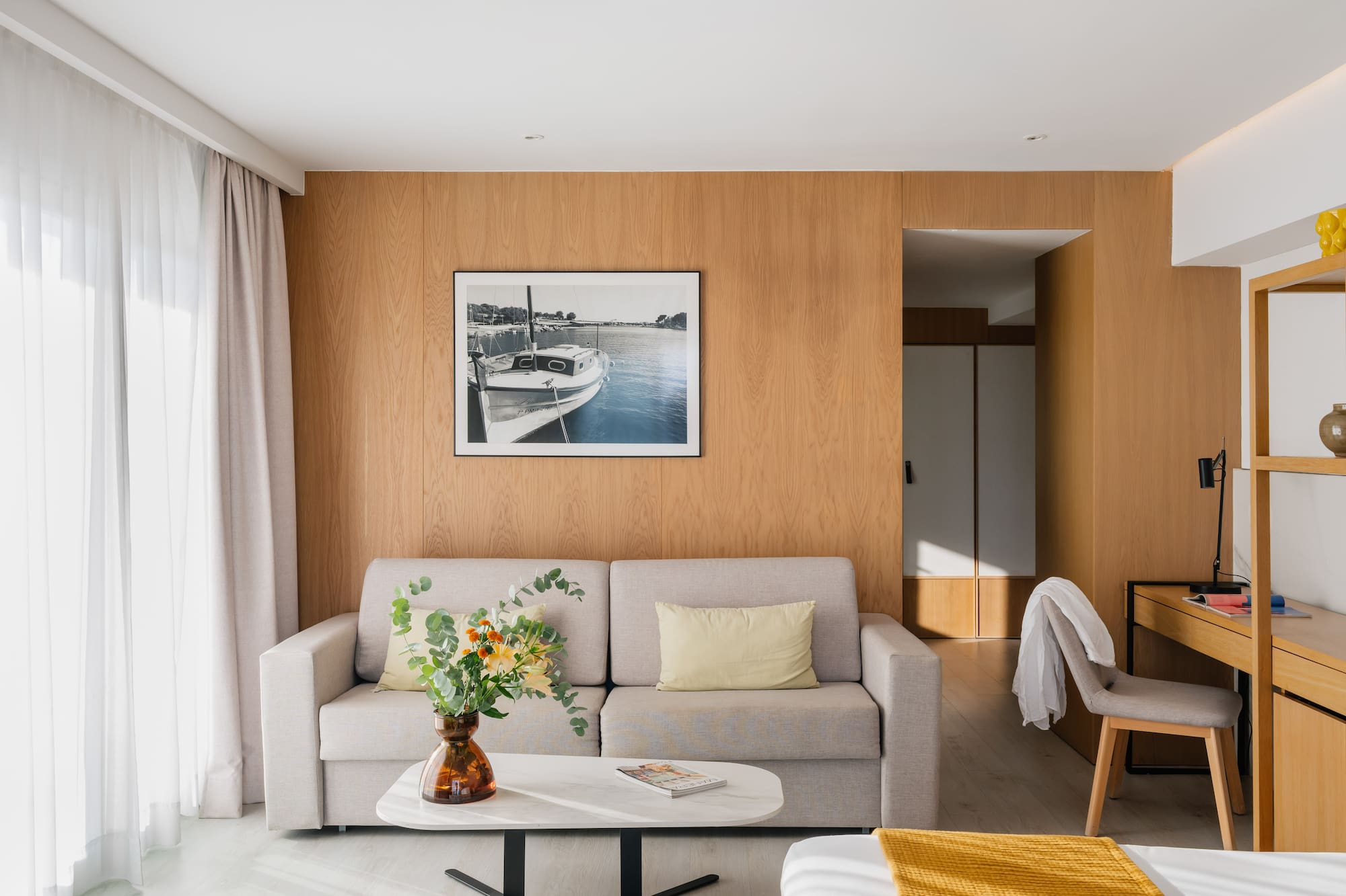 a living room with a couch and a picture on the wall