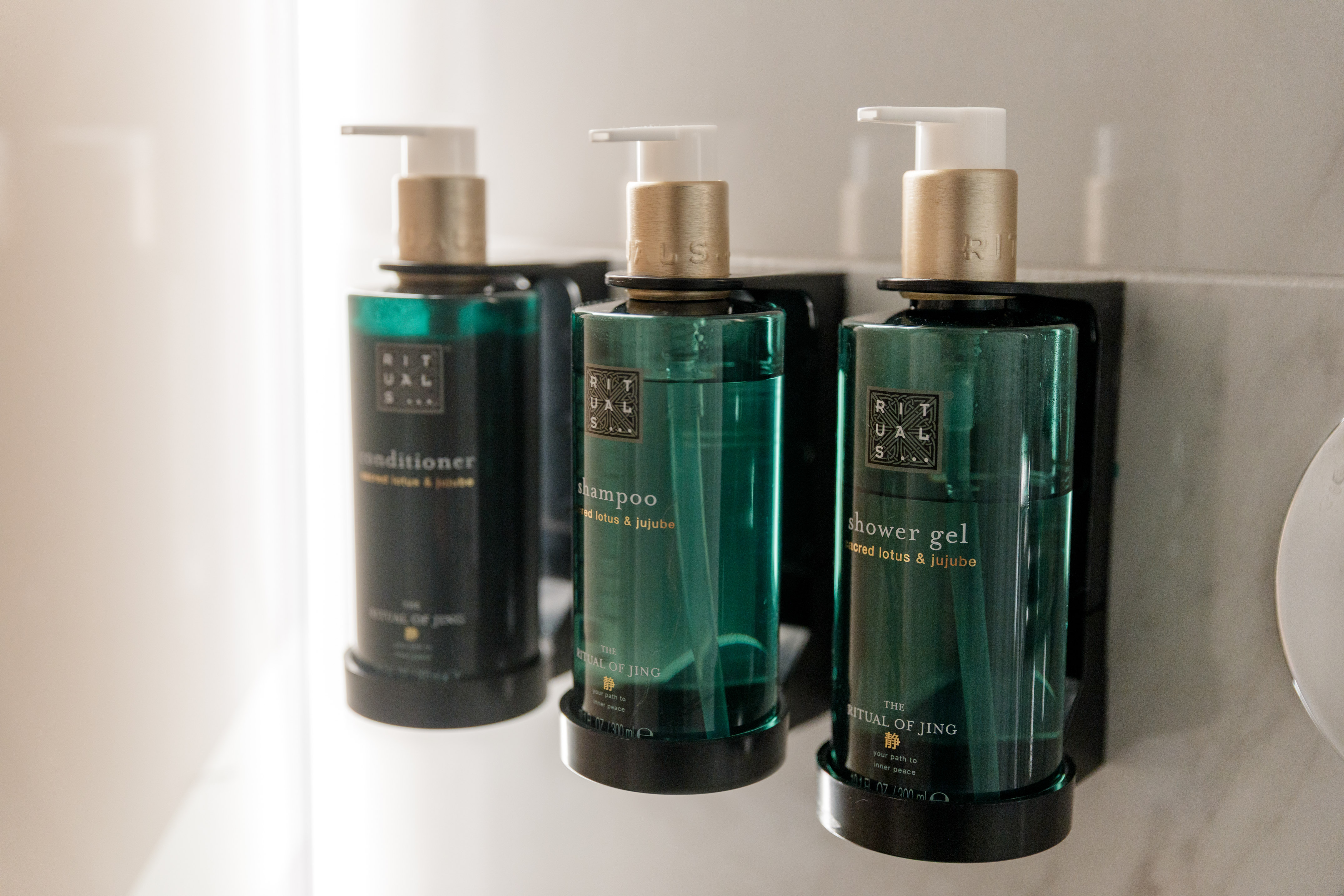 Rituals Jing lotus & jujube shampoo, conditioner, shower gel in green bottles.