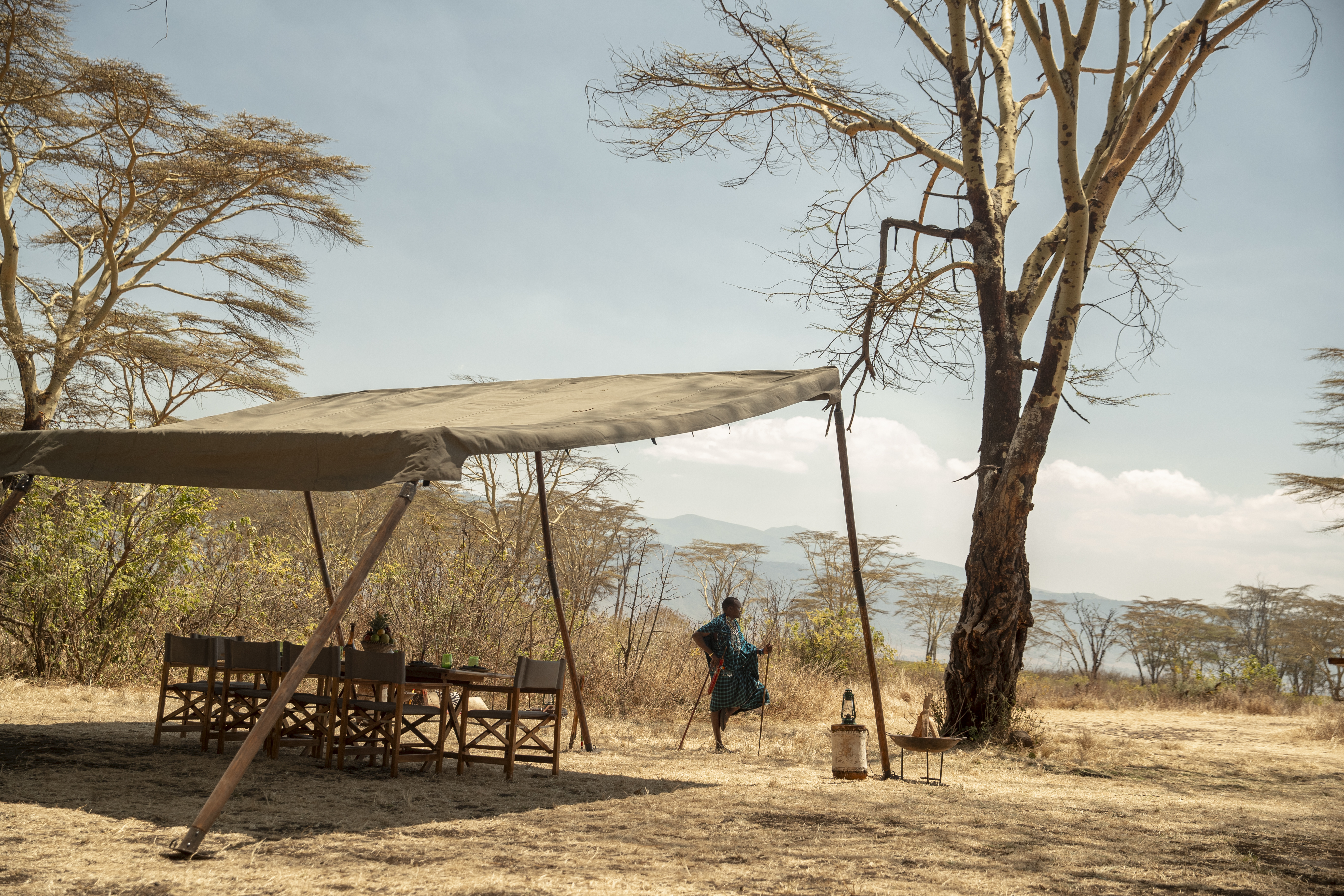 a woman standing under a tent
