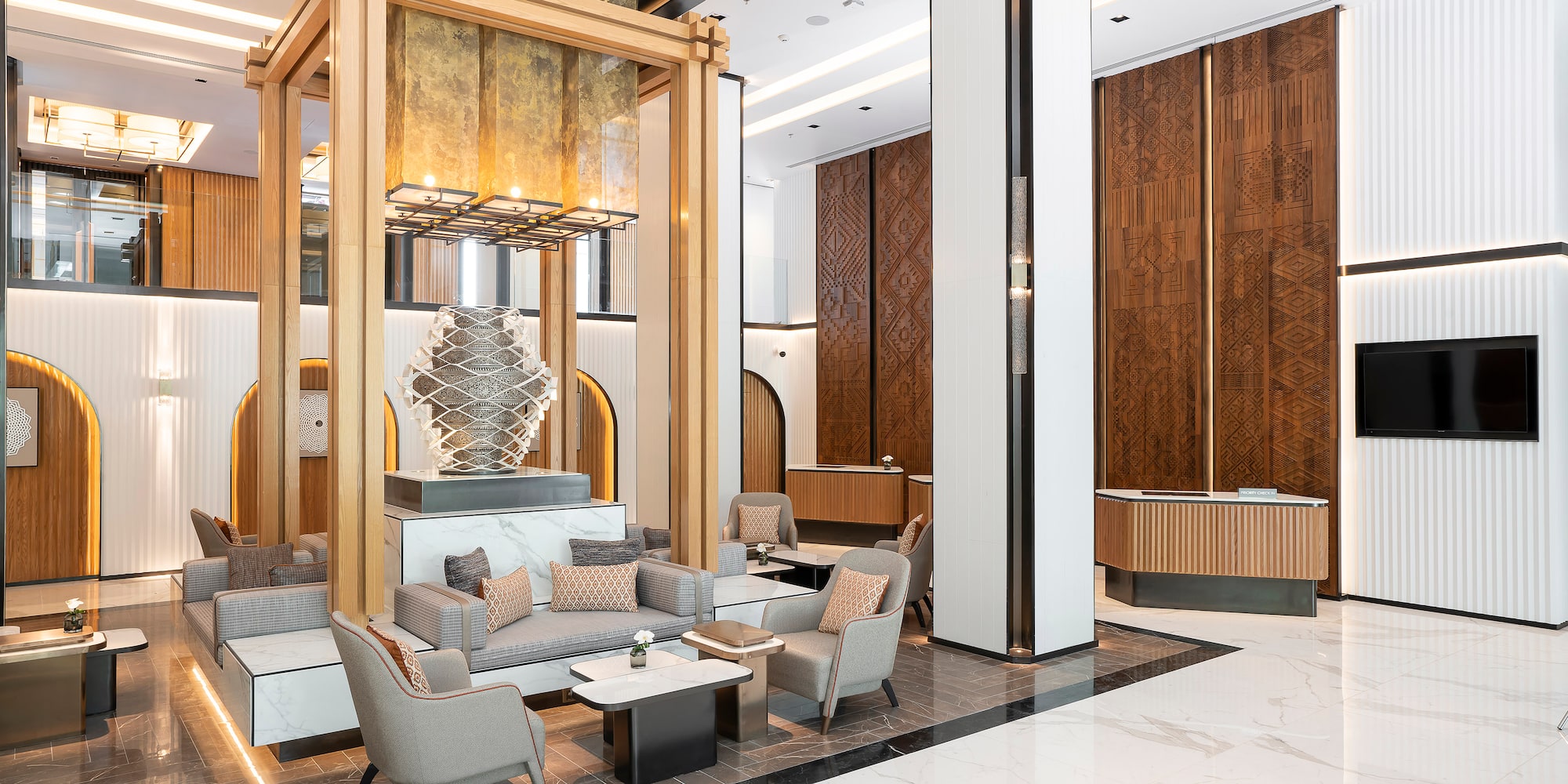 a lobby with a large wooden structure and a large chandelier