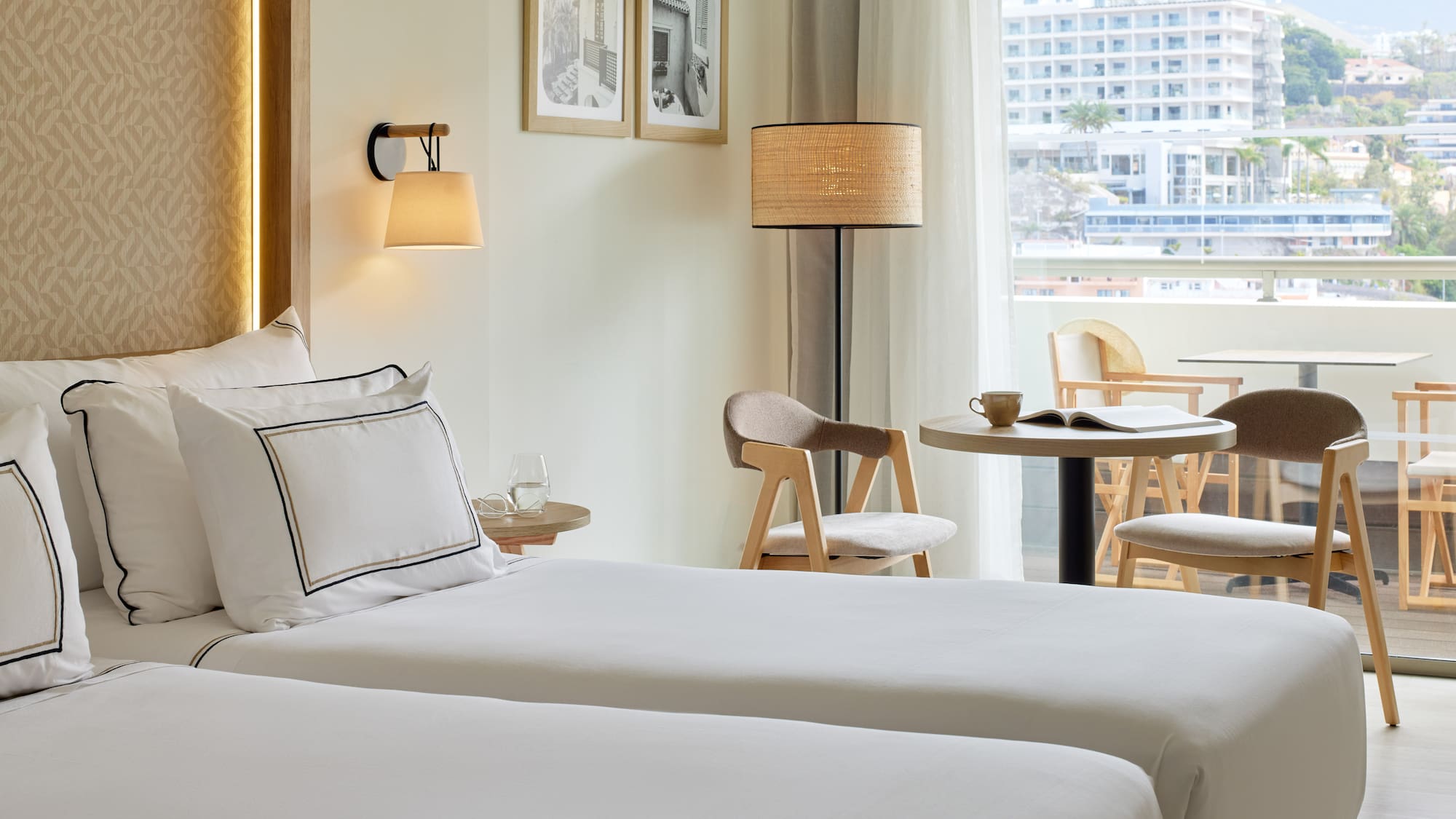 a hotel room with two beds and a table and chairs