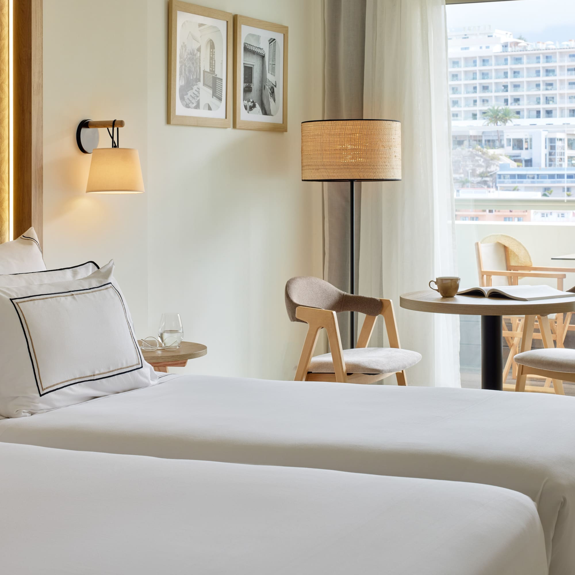 a hotel room with two beds and a table and chairs