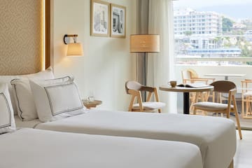 a hotel room with two beds and a table and chairs