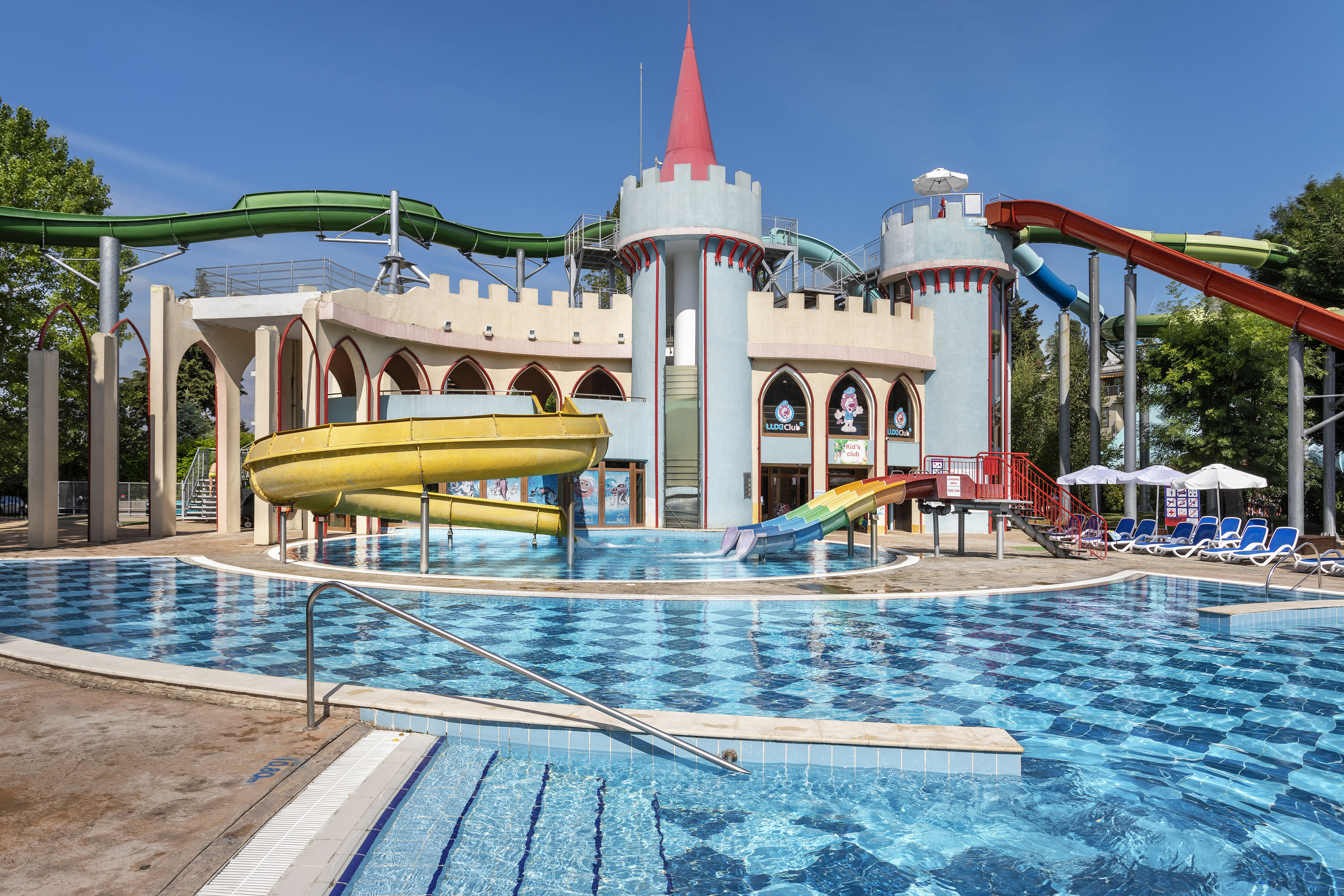 a water park with a castle and a pool