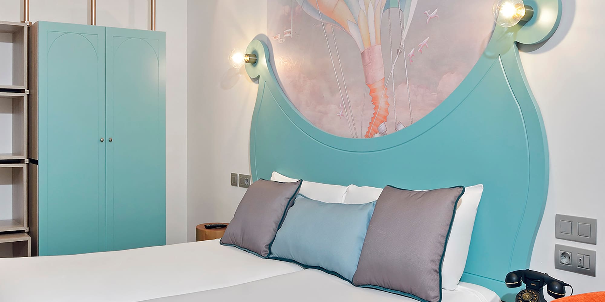 a bed with a picture on the wall