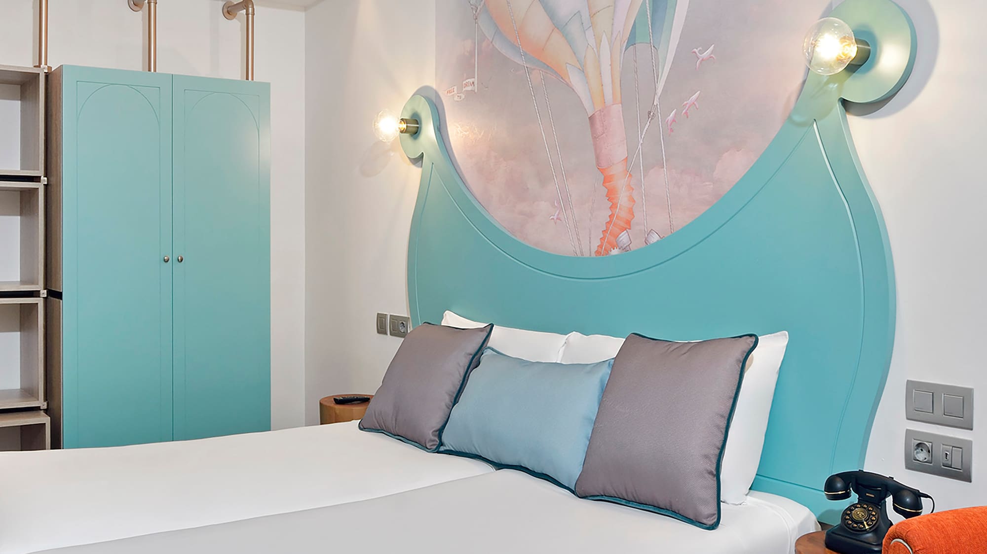 a bed with a picture on the wall