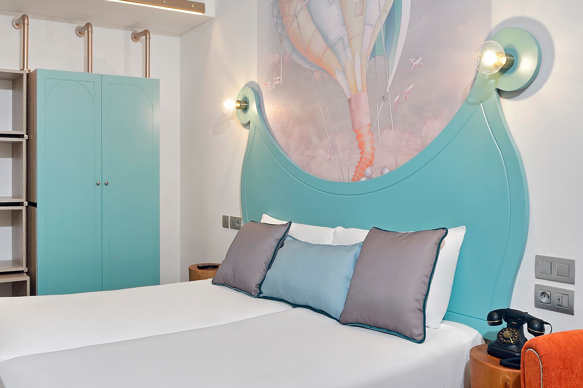 a bed with a picture on the wall