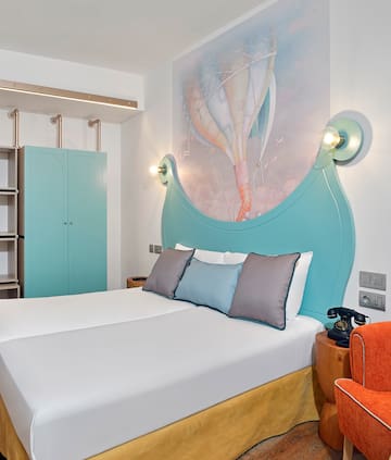 a bed with a picture on the wall