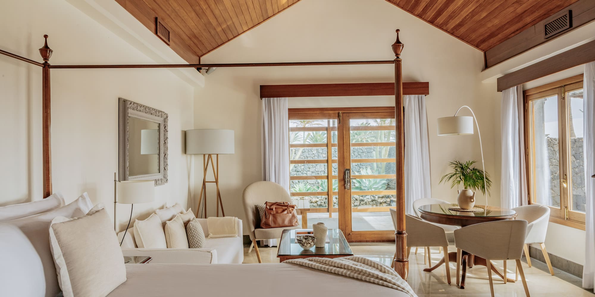 a bedroom with a bed and a table and chairs