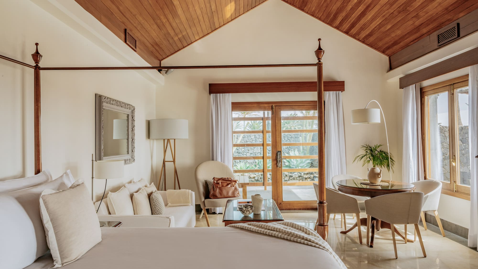 a bedroom with a bed and a table and chairs