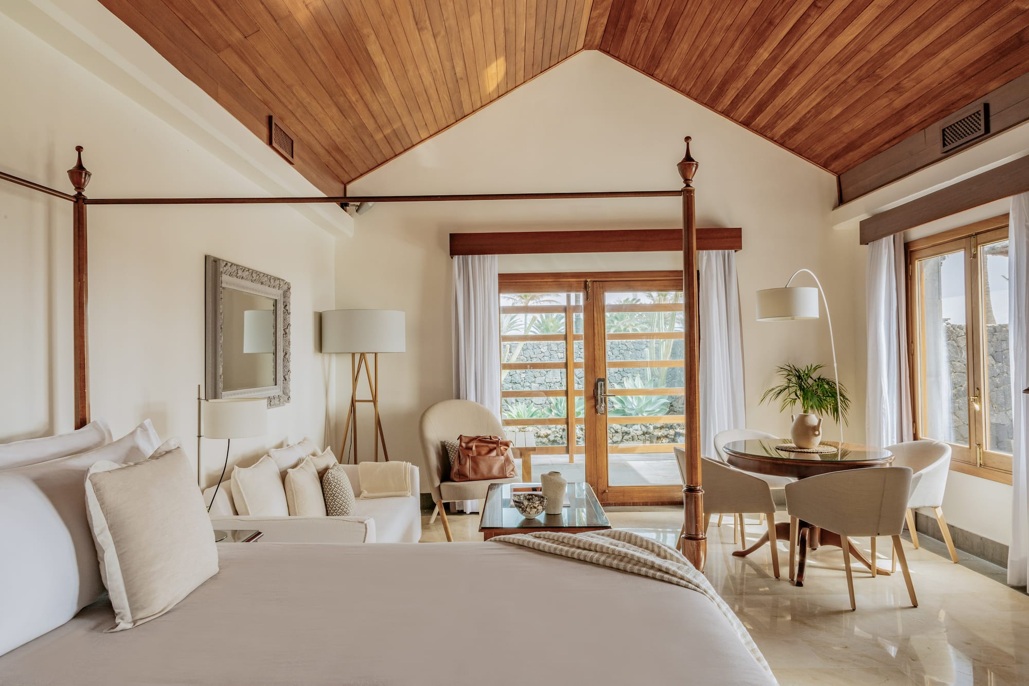 a bedroom with a bed and a table and chairs