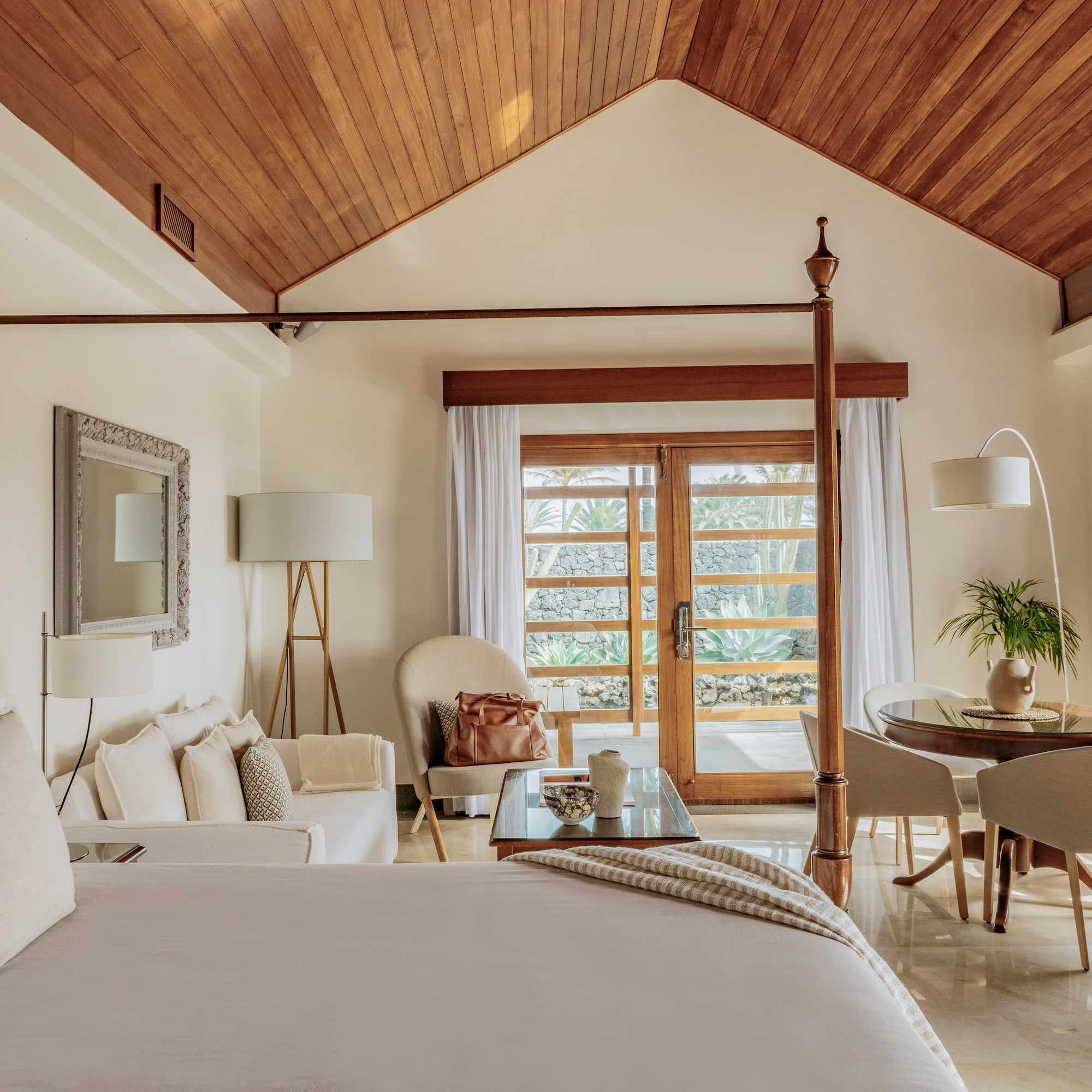 a bedroom with a bed and a table and chairs