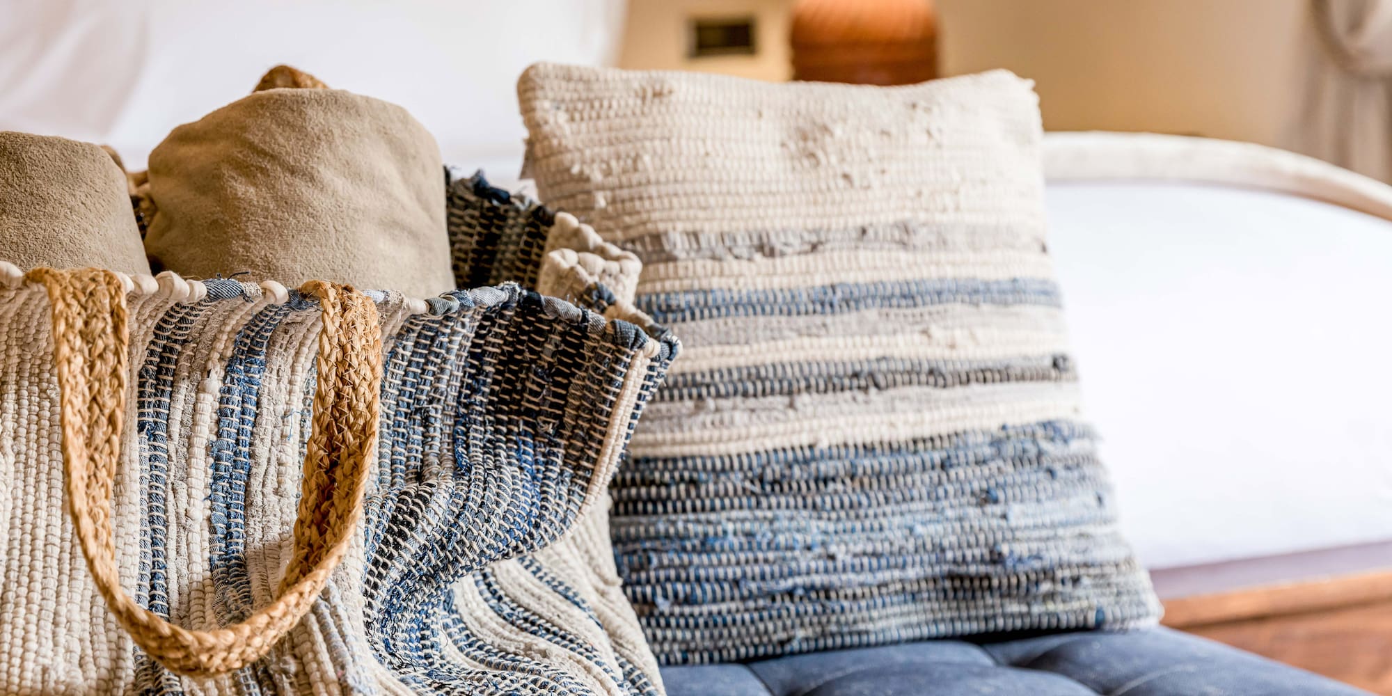 a bag and pillow on a couch