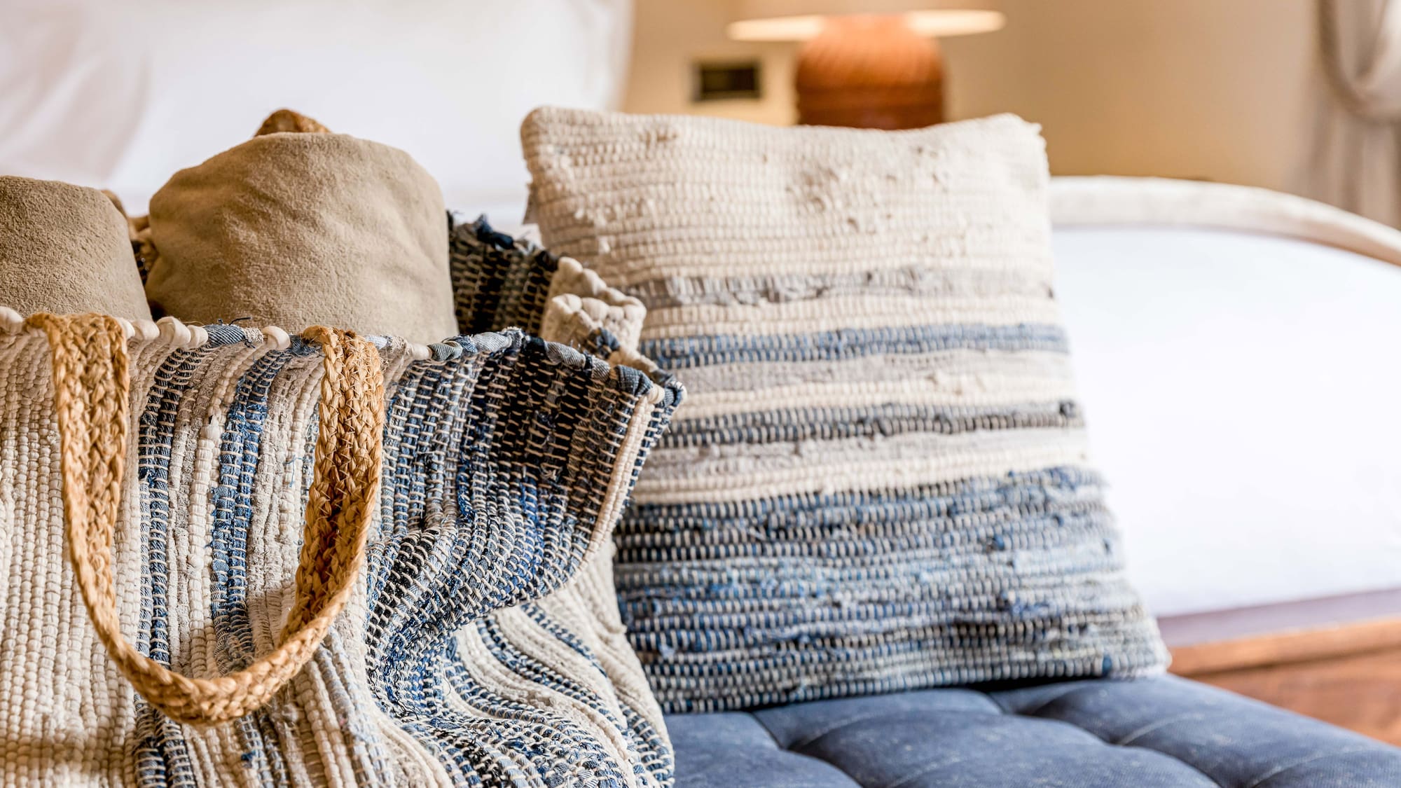 a bag and pillow on a couch