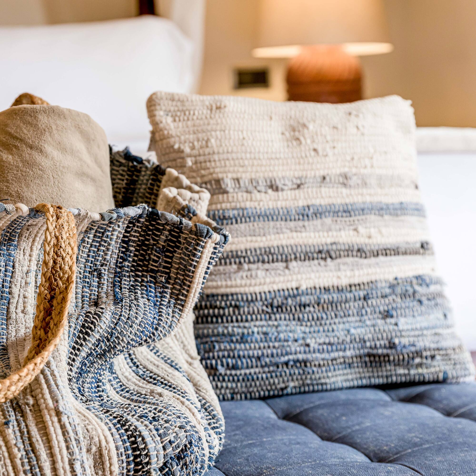 a bag and pillow on a couch