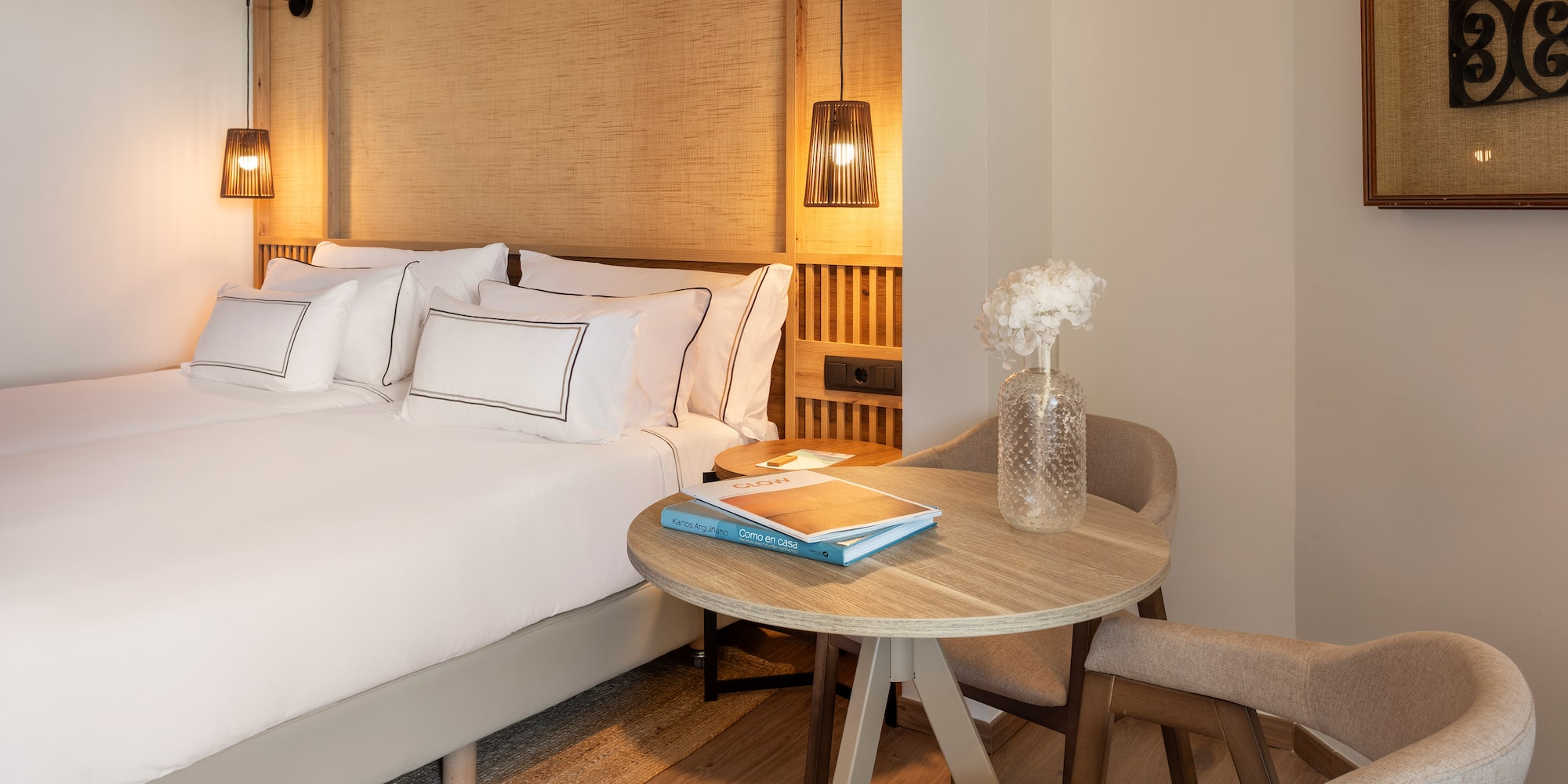 a room with a bed and chairs