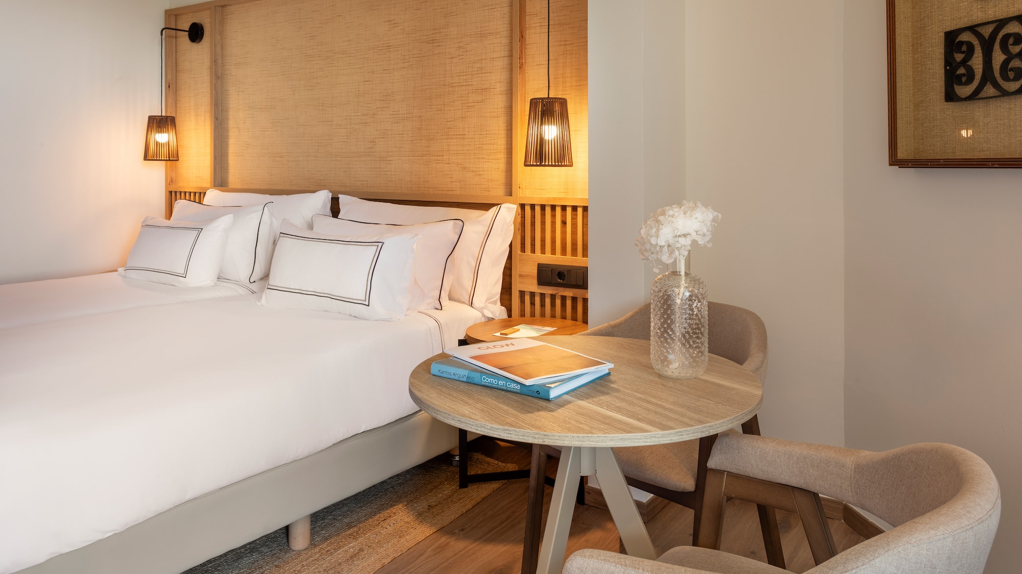 a room with a bed and chairs