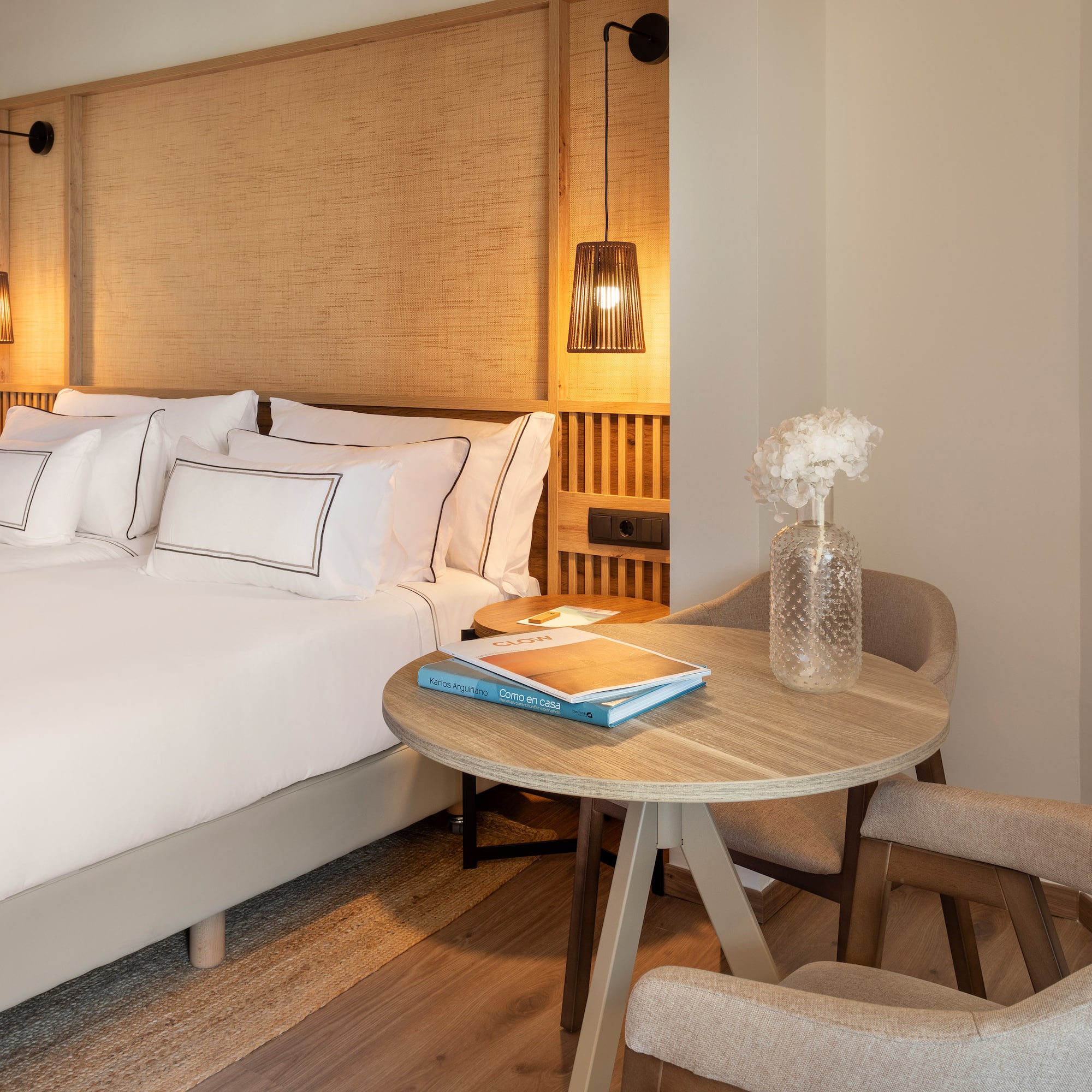 a room with a bed and chairs