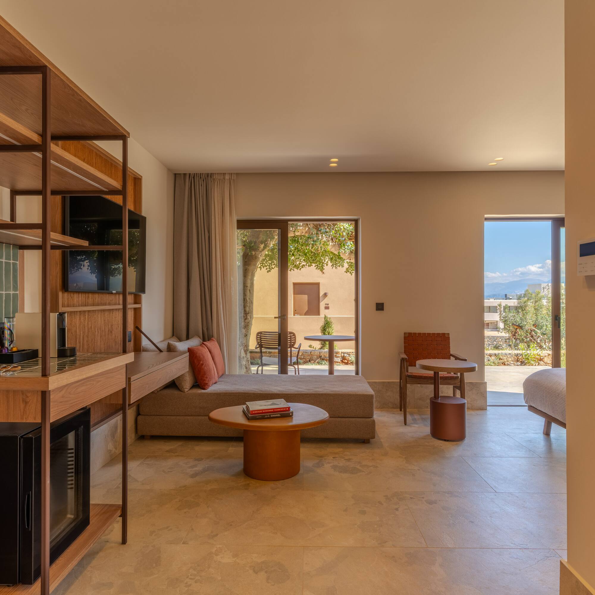 a room with a bed and a television