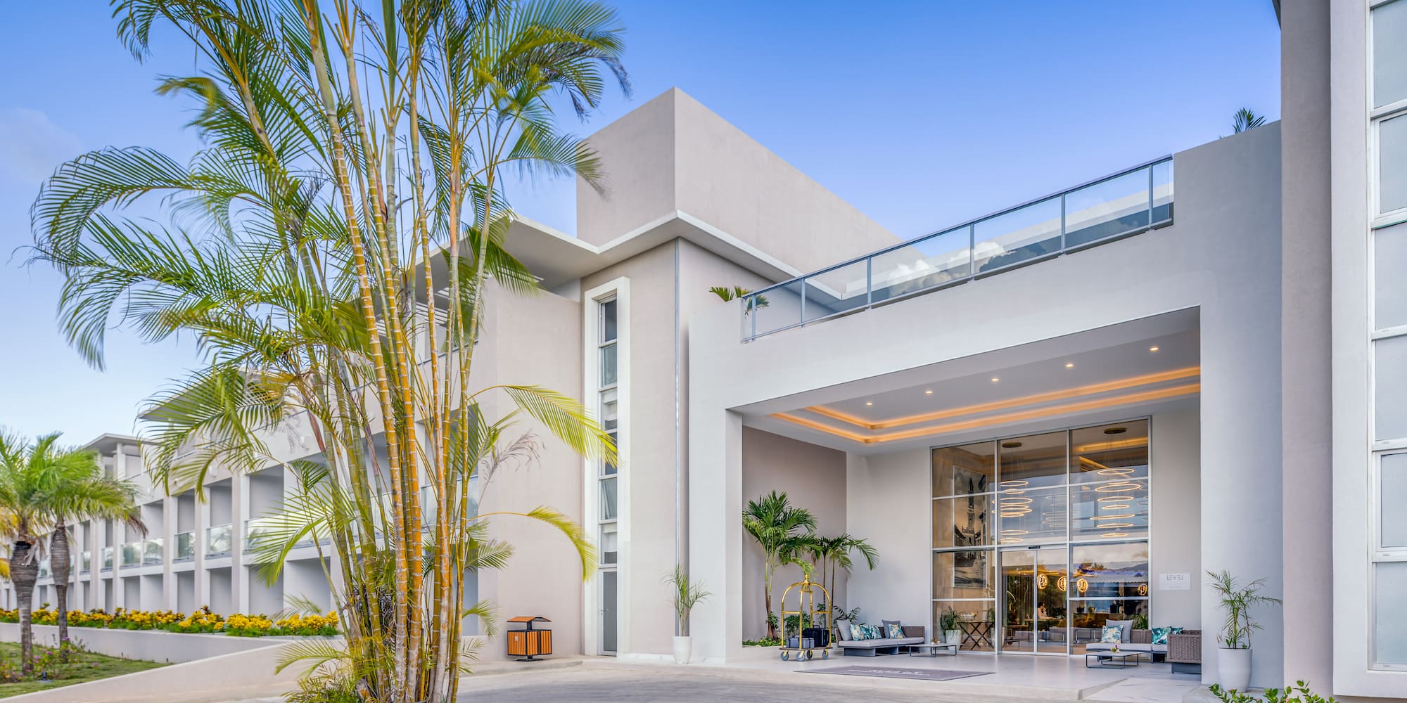 a building with a balcony and palm trees