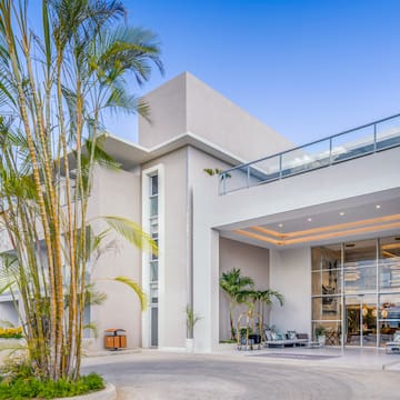 a building with a balcony and palm trees