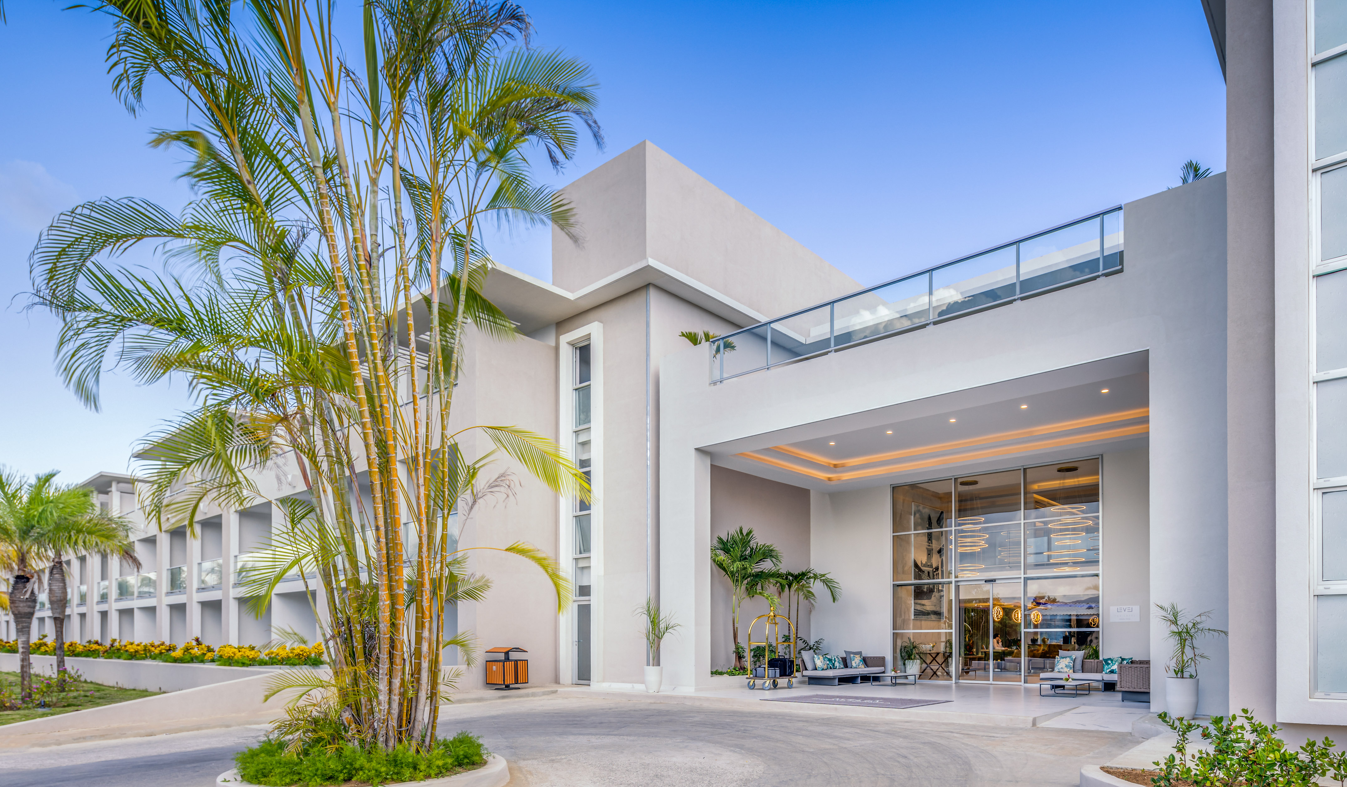 a building with a balcony and palm trees