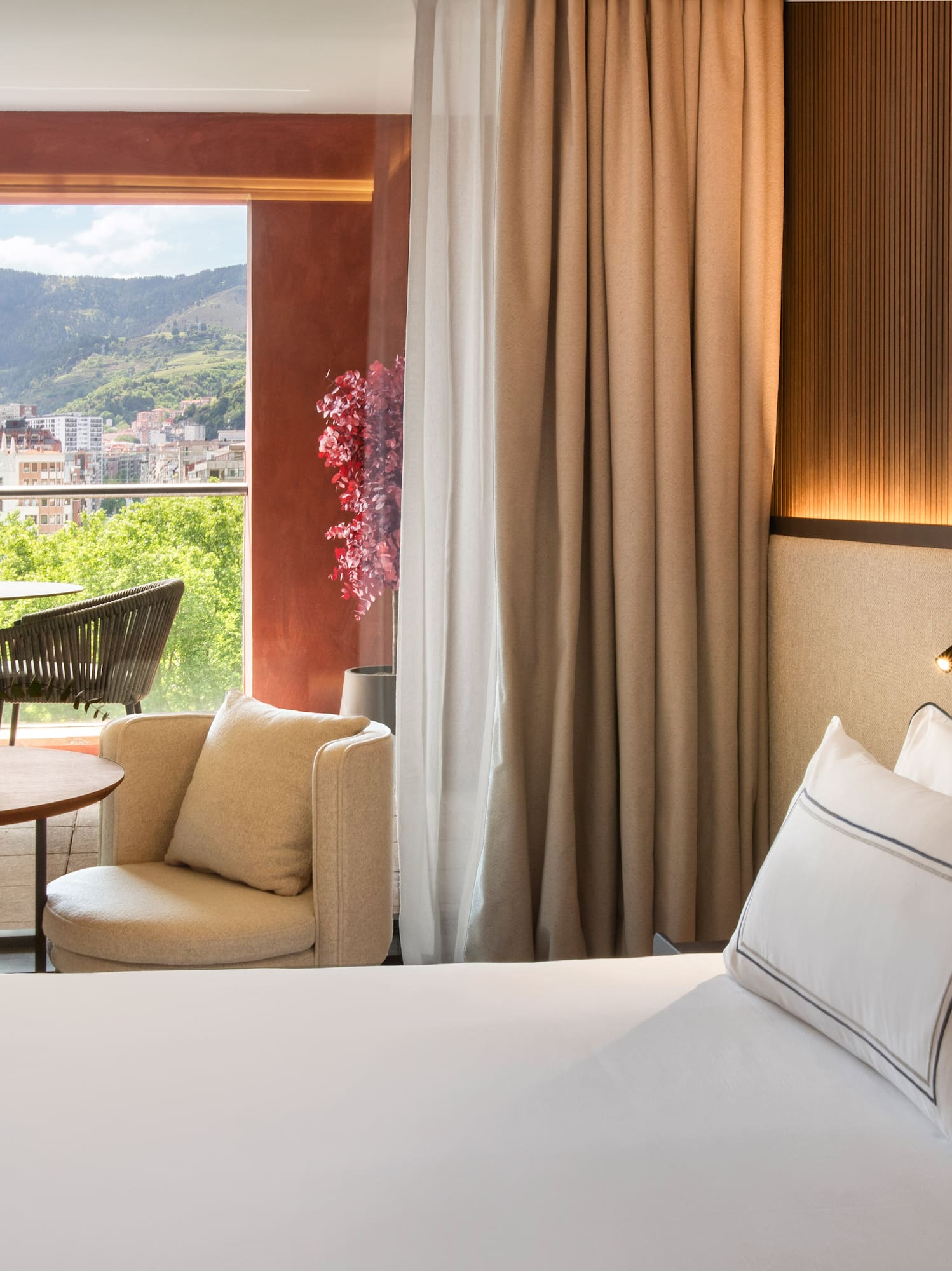 a room with a bed and a table and chairs