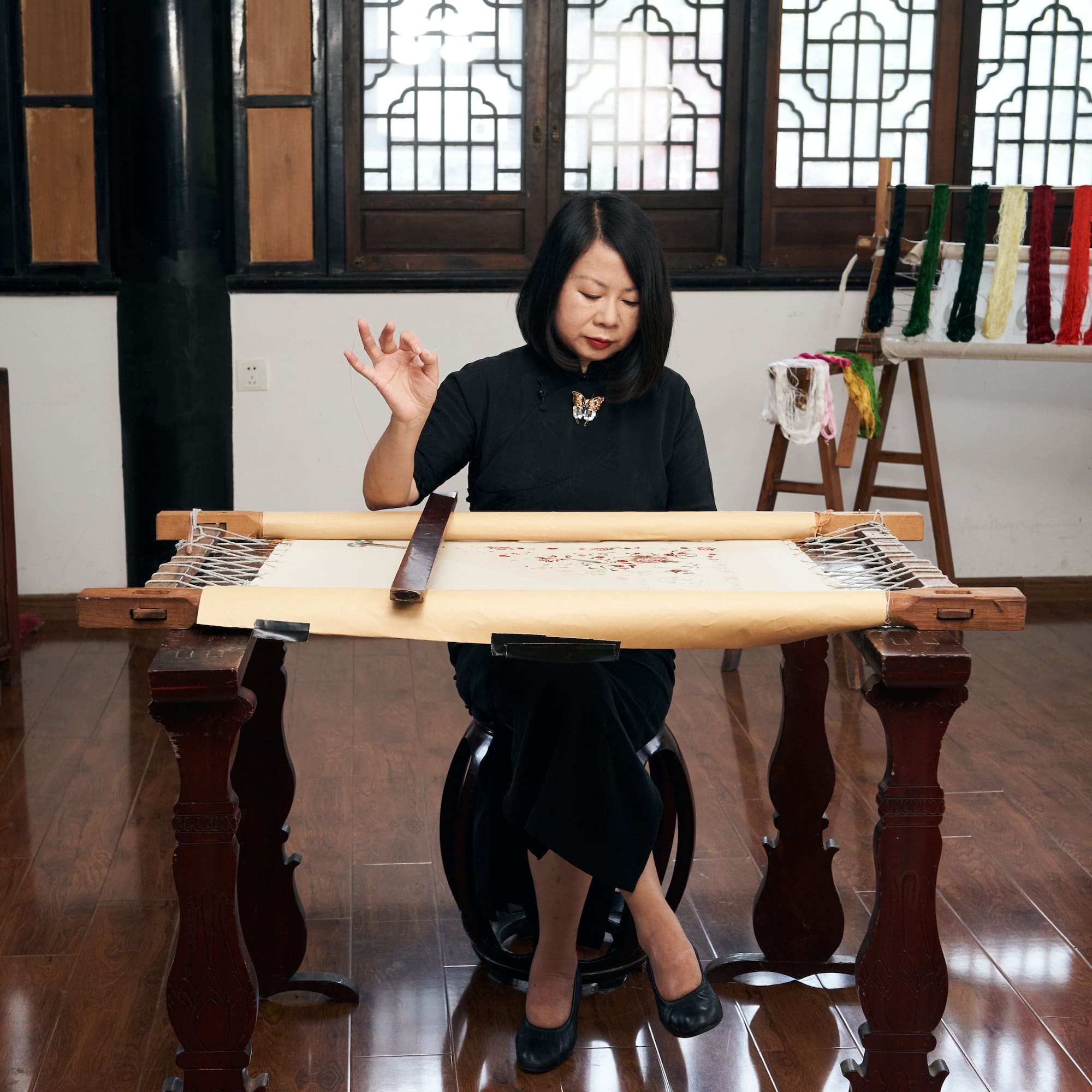 a woman sitting at a table with a scroll