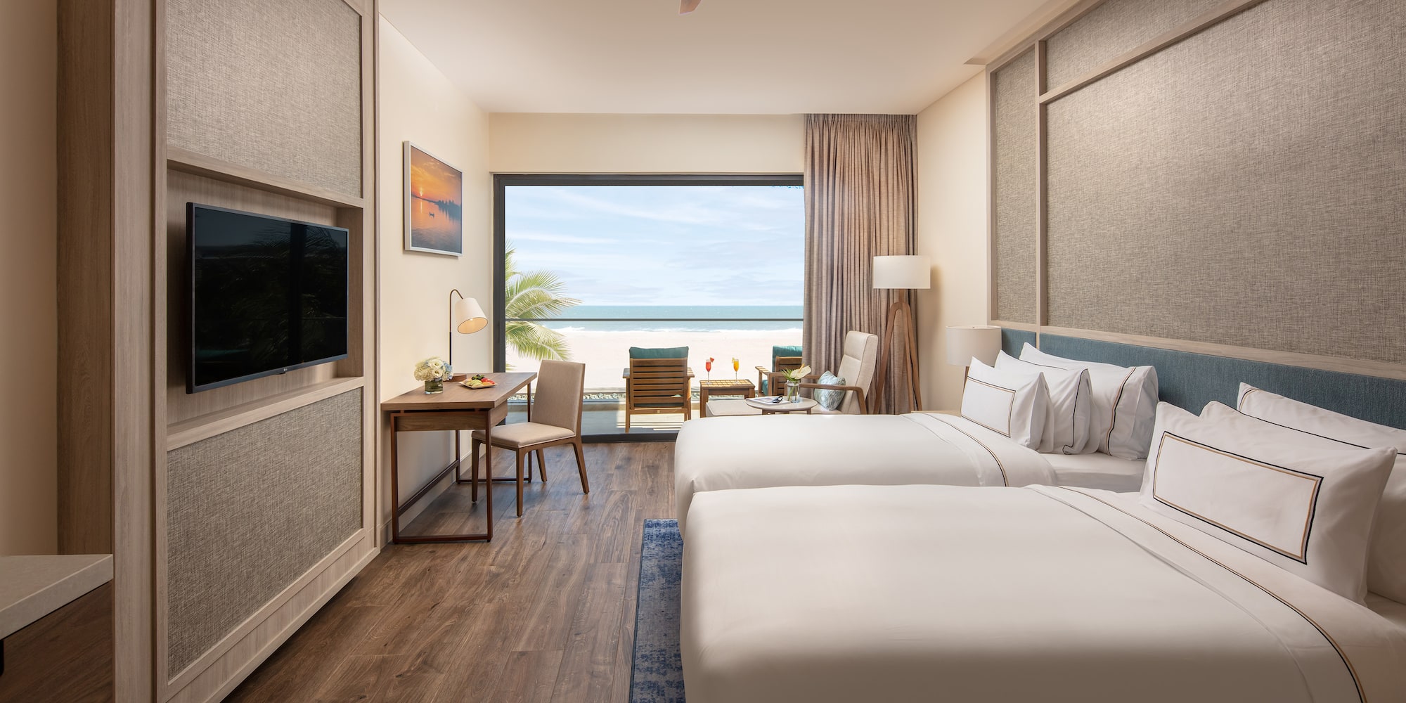 a room with two beds and a television