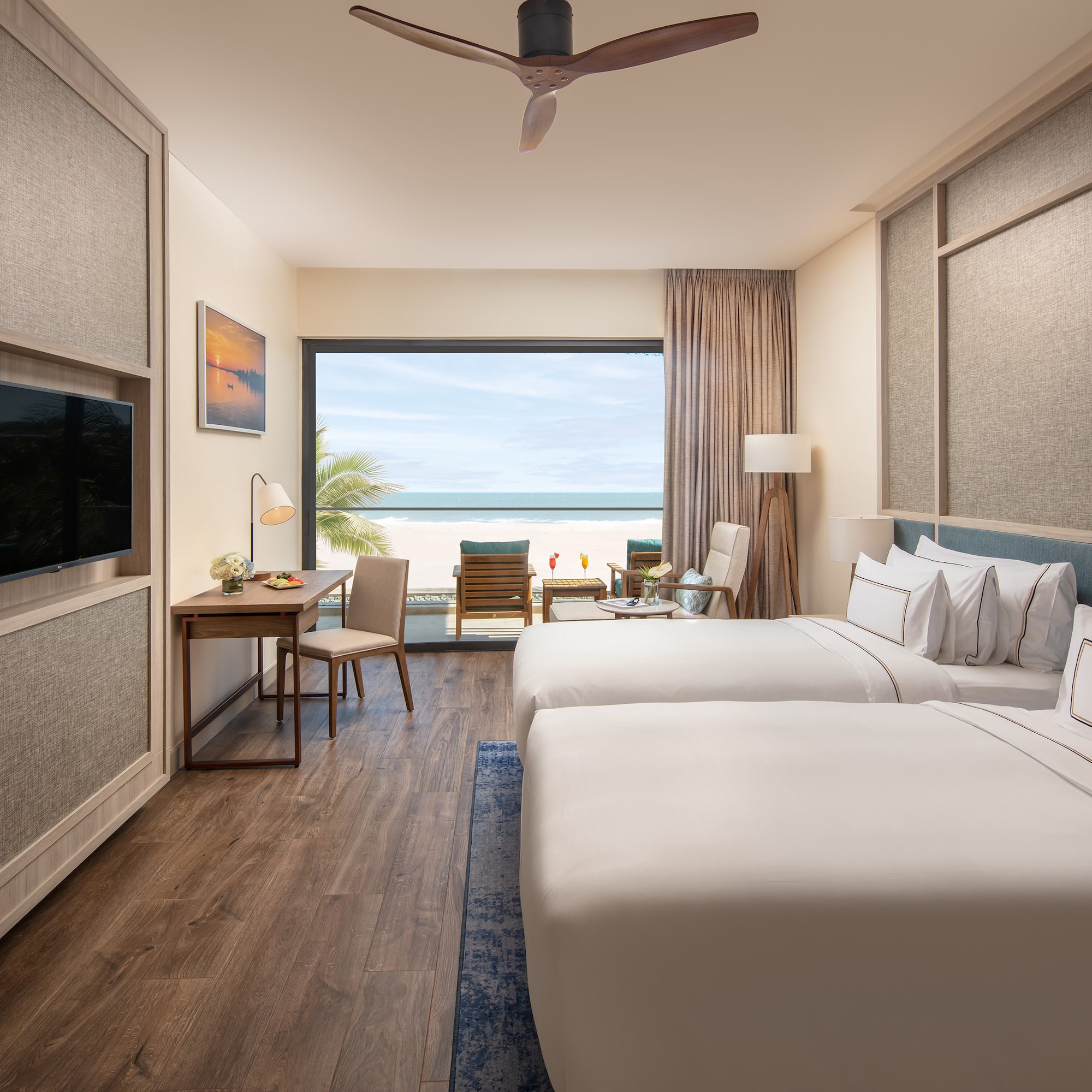 a room with two beds and a television