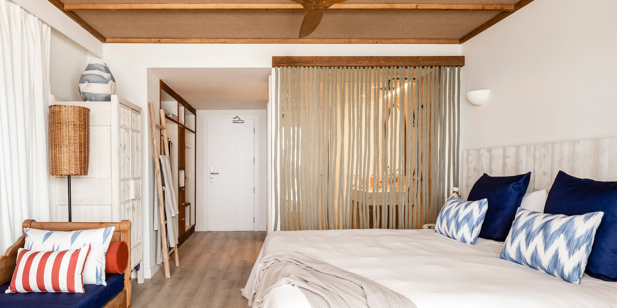 a room with a bed and a fan