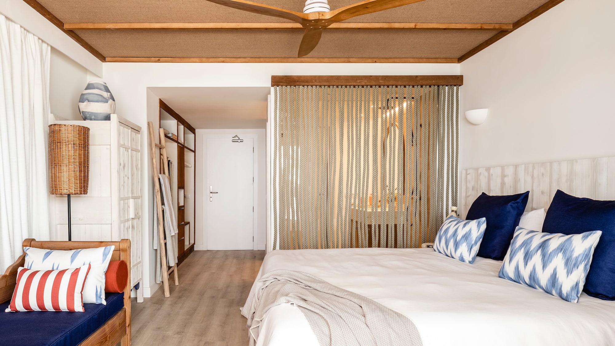 a room with a bed and a fan