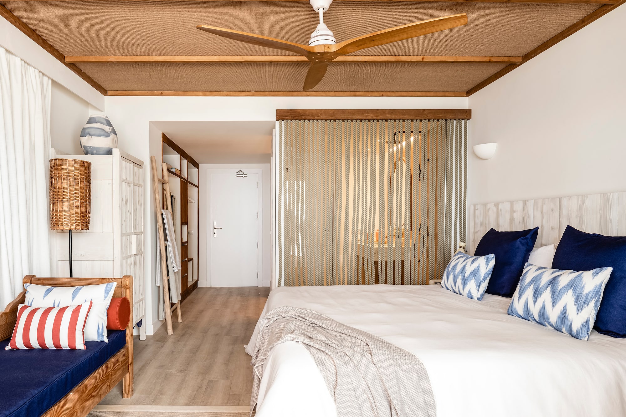 a room with a bed and a fan