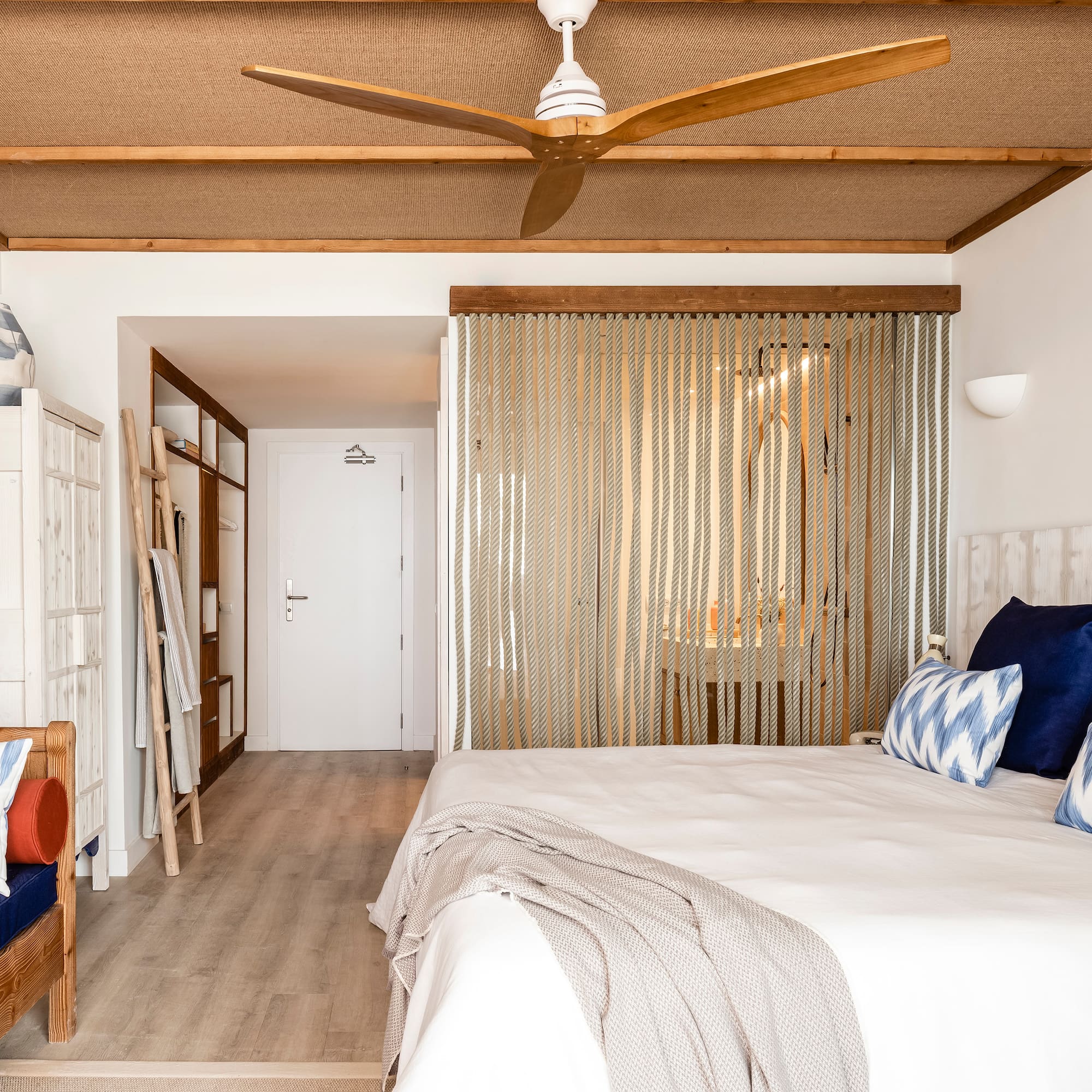 a room with a bed and a fan